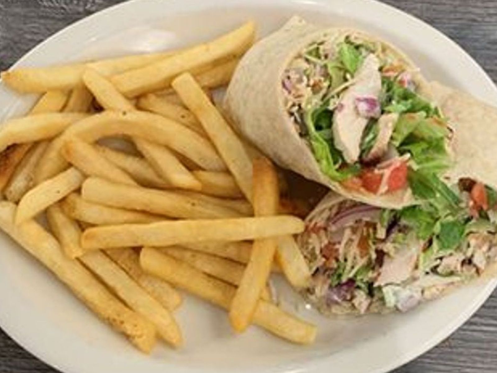 Order Grilled Chicken Caesar Wrap- OO food online from Biscuits Cafe store, Chandler on bringmethat.com