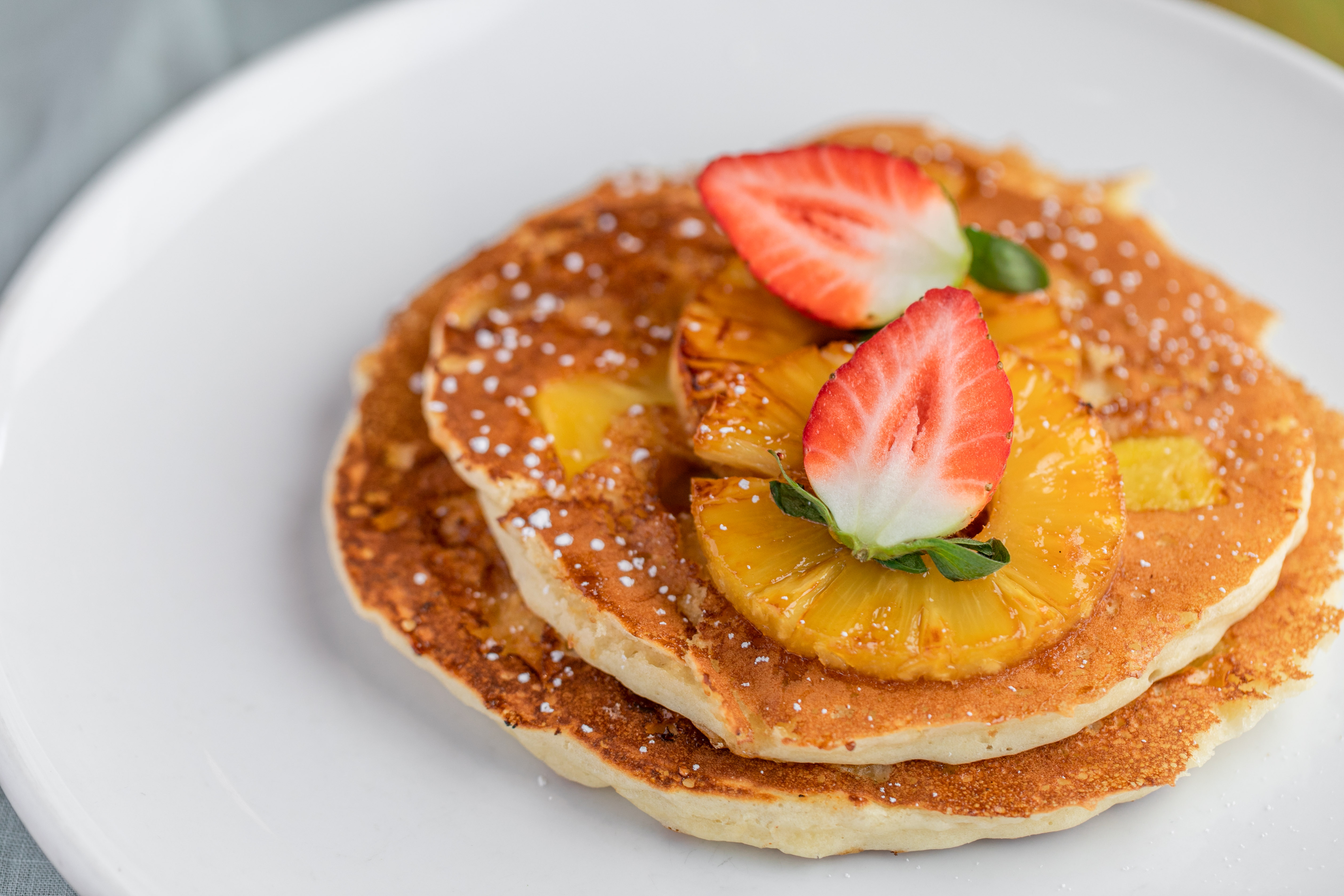 Order Pineapple Upside Down Pancakes* food online from Swami Cafe store, San Diego on bringmethat.com
