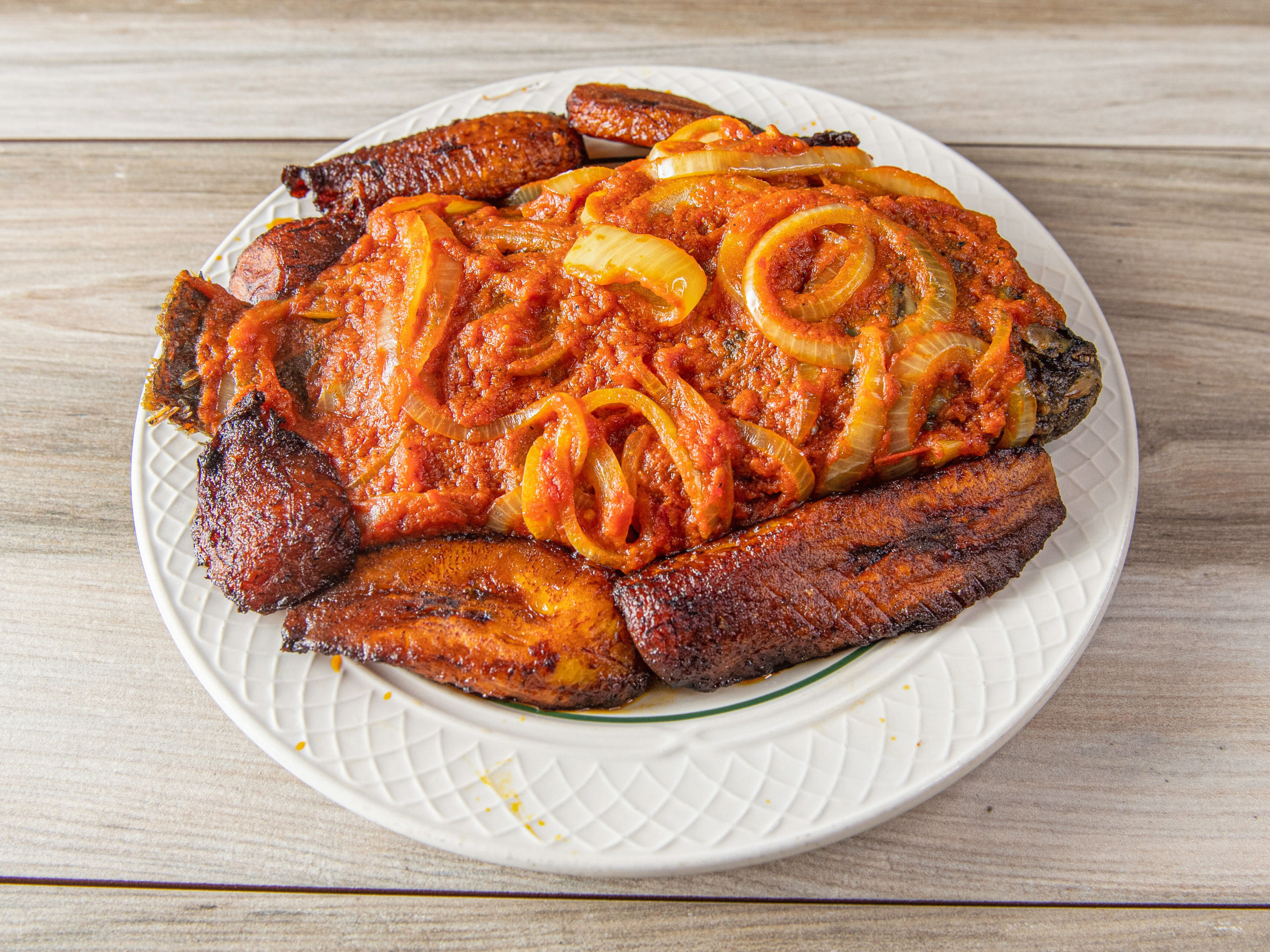Order Whole Fried Tilapia with Onion Stew  food online from Mas&J International Restaurant store, Mableton on bringmethat.com