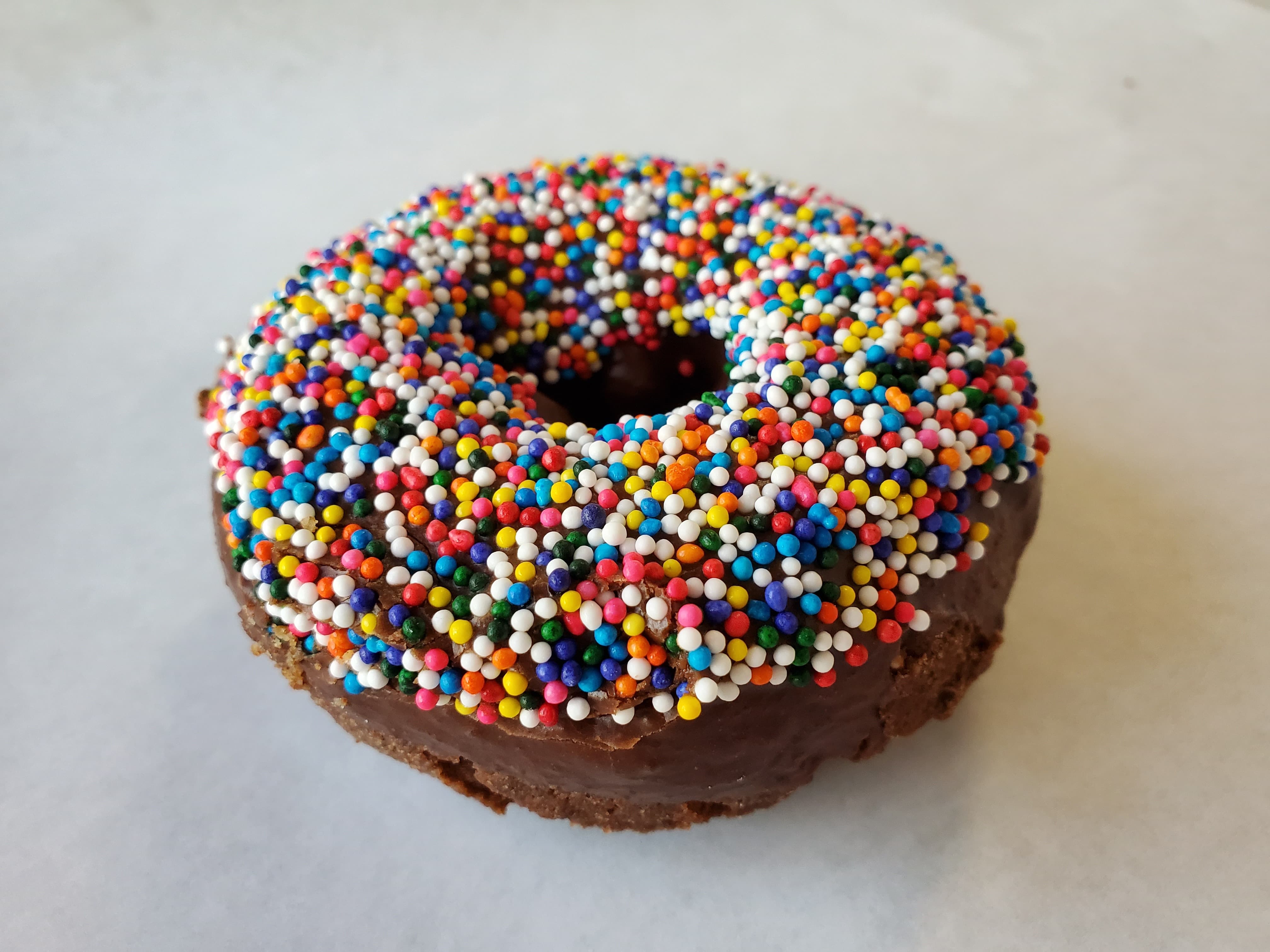 Order Rainbow Sprinkle on chocolate frosted cake food online from Honey Donuts store, Crowley on bringmethat.com