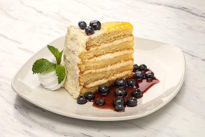 Order 5 Layer Lemon Cake food online from Firebirds Wood Fired Grill store, Orange on bringmethat.com