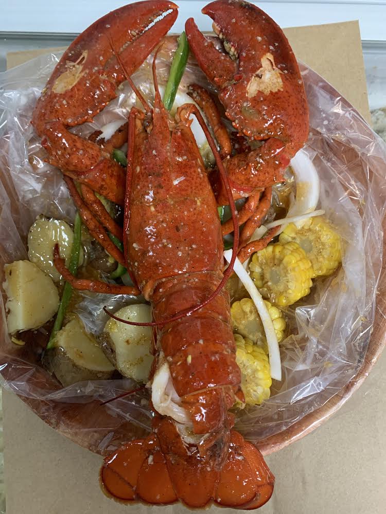 Order Whole lobster served with potato and corn food online from Jamaica fish market store, Richmond Hill on bringmethat.com