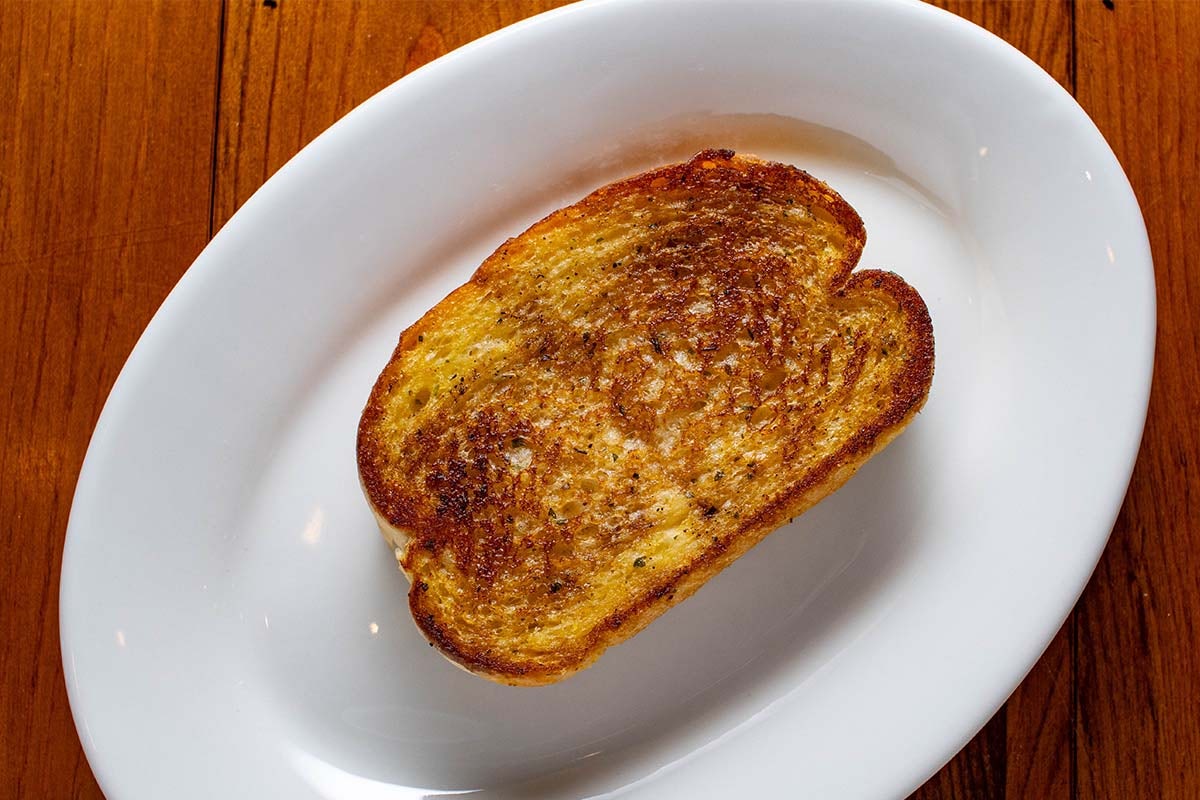 Order Garlic Toast food online from Boudreaux Cajun Kitchen store, Houston on bringmethat.com