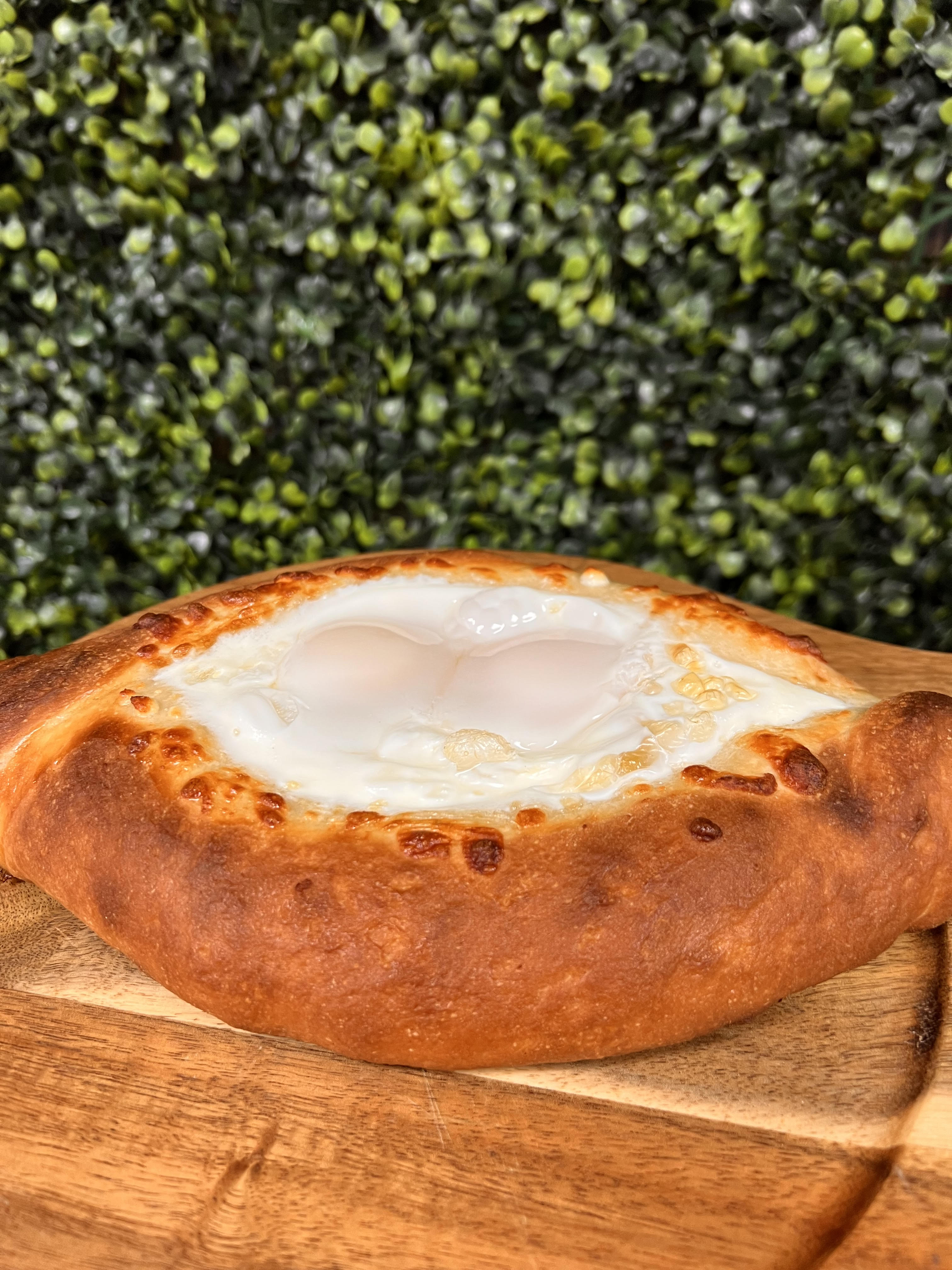 Order Ajarian Khachapuri with 2 egg food online from Ossys Bakery store, Glendale on bringmethat.com