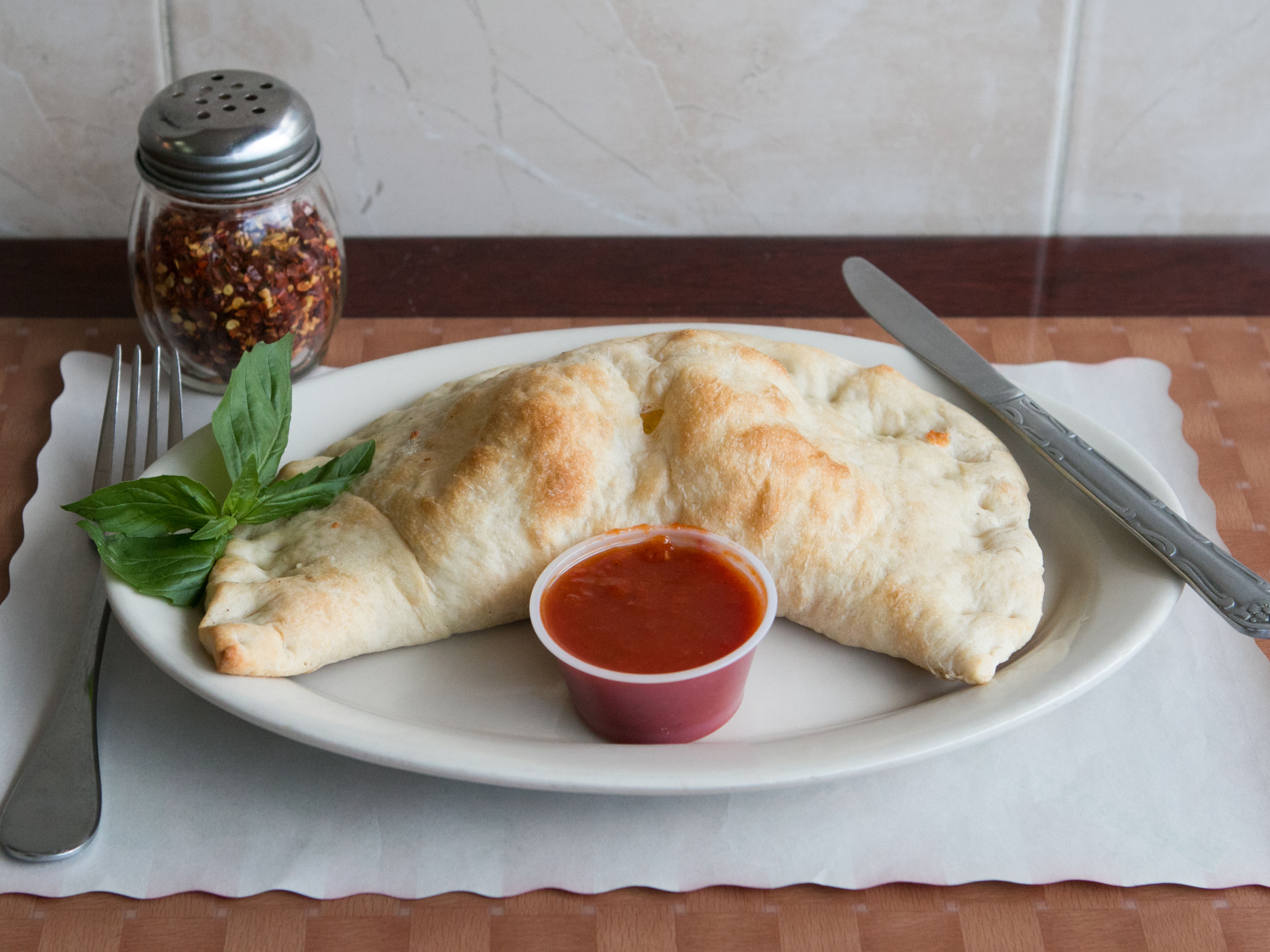 Order Calzone food online from Geo's Pizzeria & Restaurant store, Richmond Hill on bringmethat.com