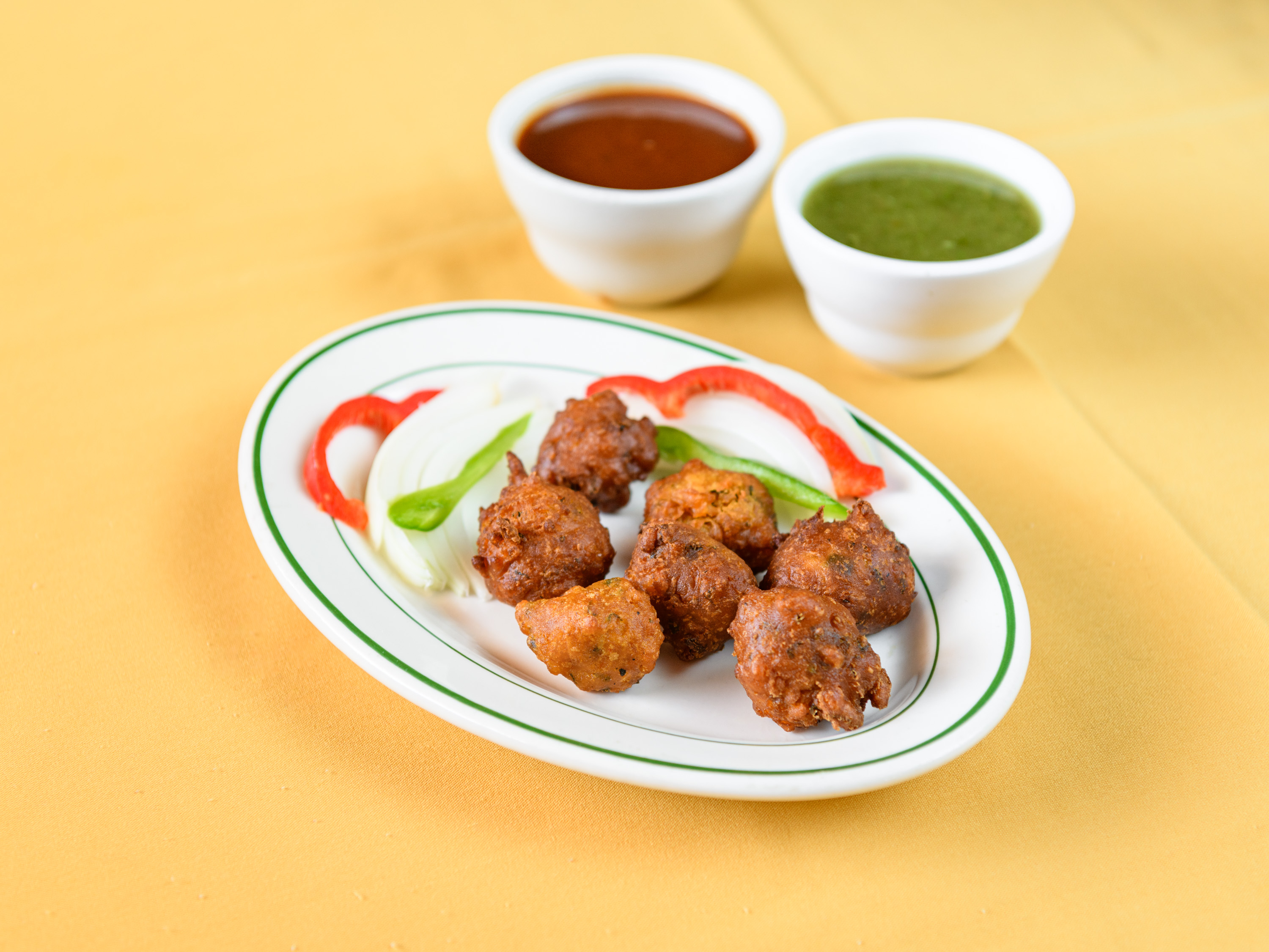 Order Onion Pakoda food online from Taj Cuisine of India store, Oklahoma City on bringmethat.com