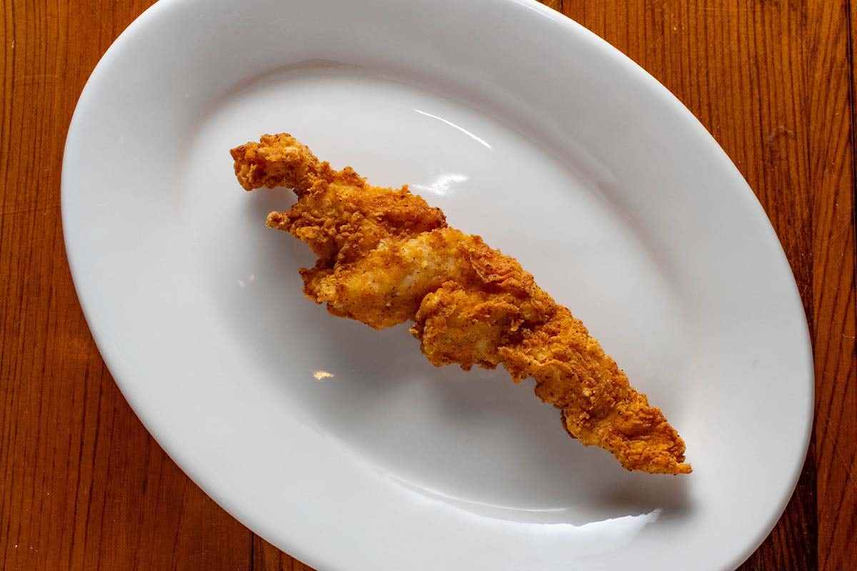 Order Chicken Tender - 1 food online from Boudreaux's Cajun Kitchen store, Houston on bringmethat.com