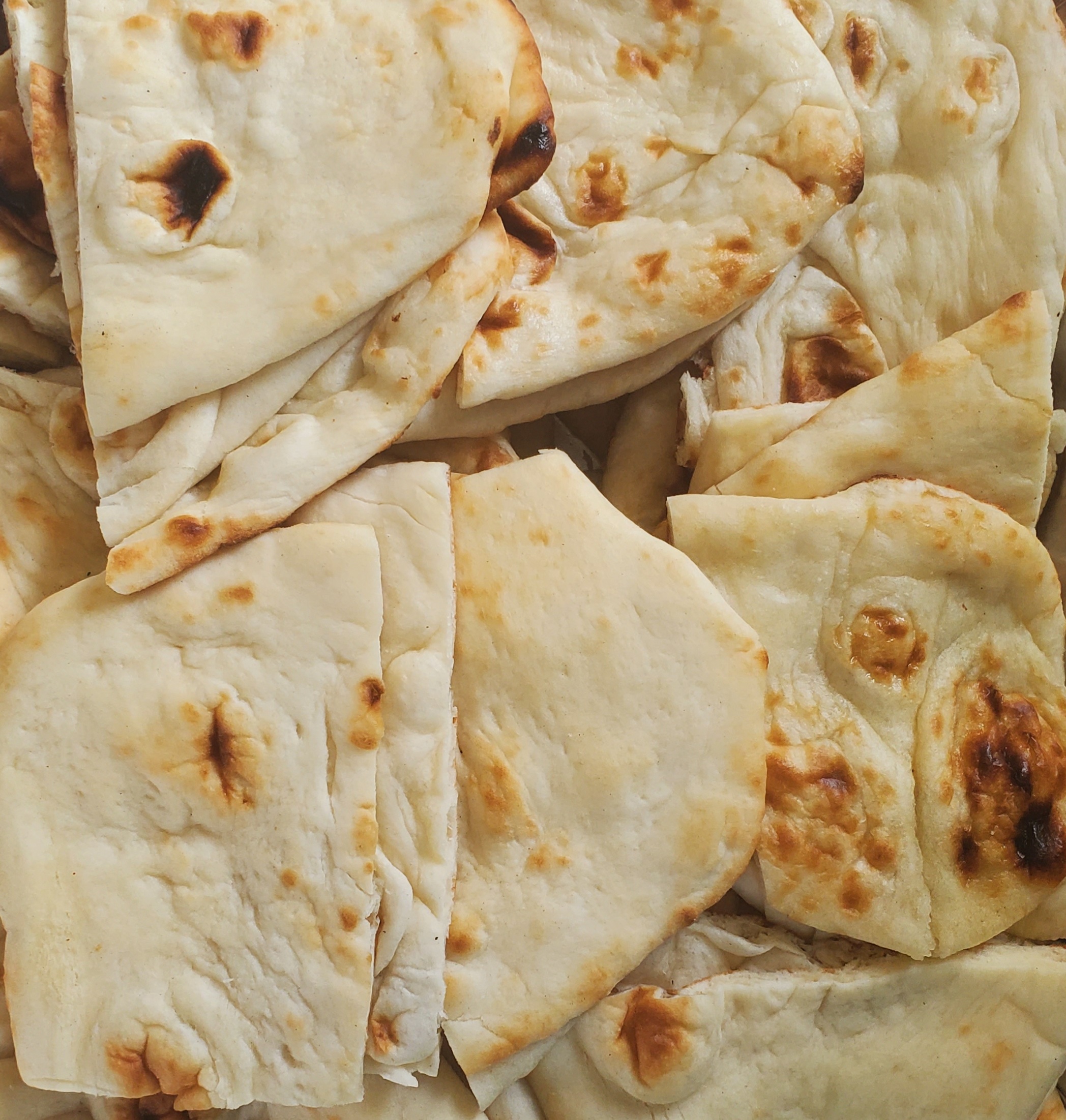 Order Naan or Garlic Naan (5 cut pieces of naan) food online from Shirleys India store, New Rochelle on bringmethat.com
