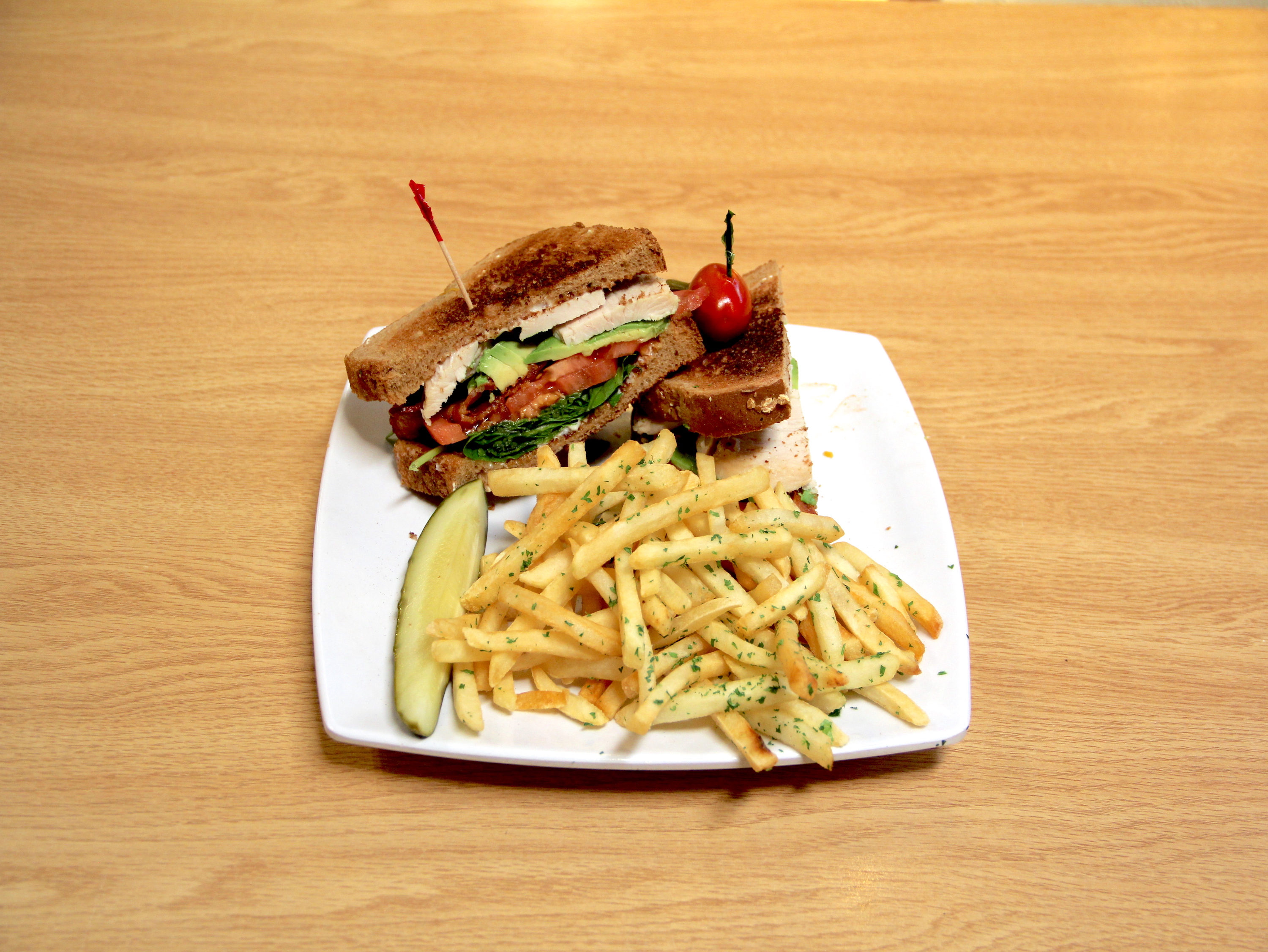 Order Turkey Avocado Club Sandwich food online from Hunnys Cafe store, Corona on bringmethat.com