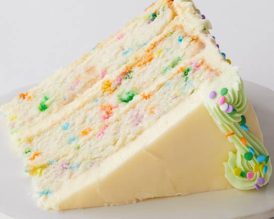 Order Confetti Cake Slice to go food online from Magnolia Bakery Bleecker Street store, New York on bringmethat.com