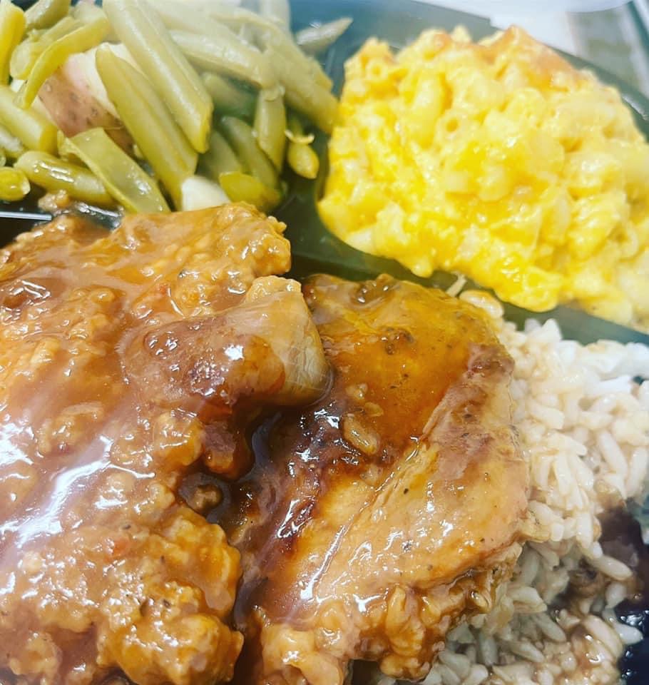 Order Smothered Porkchops with Rice food online from Kisha's Kitchen store, Chicago on bringmethat.com