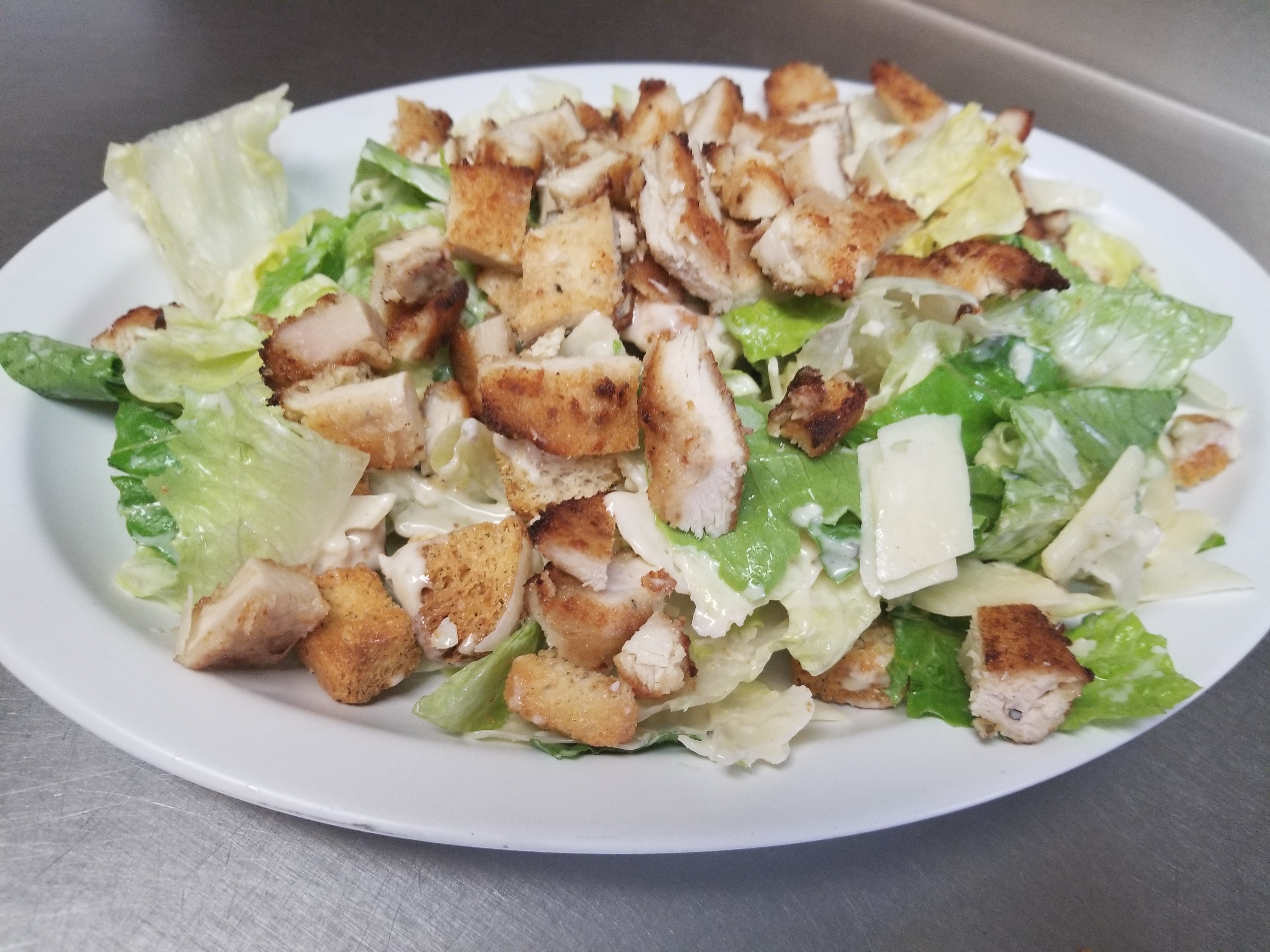 Order Caesar Salad food online from Pizzarelli's Pizza store, Scarsdale on bringmethat.com