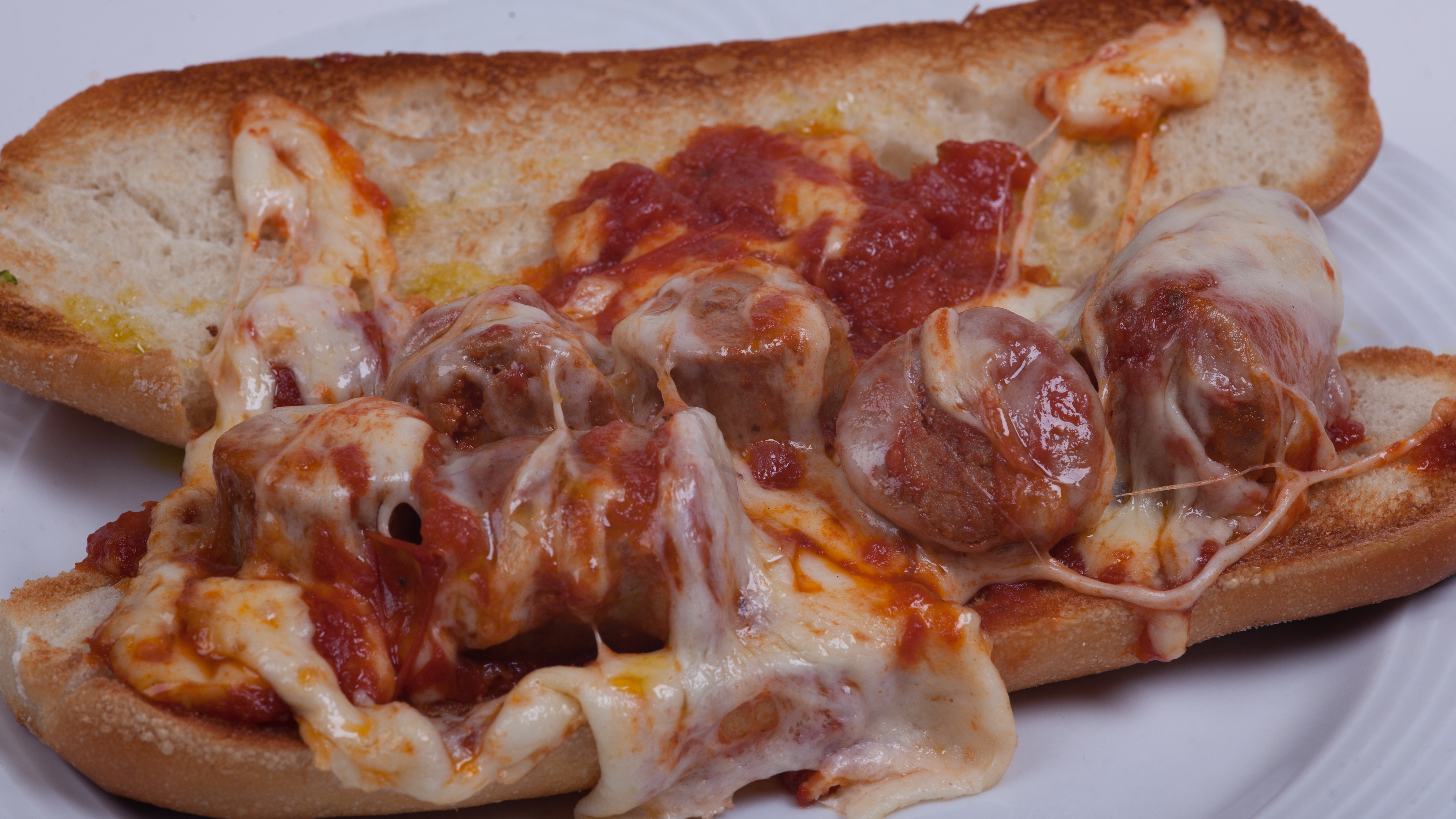 Order Sausage Parmigiana Hero food online from Umberto's Pizzeria store, New Hyde Park on bringmethat.com