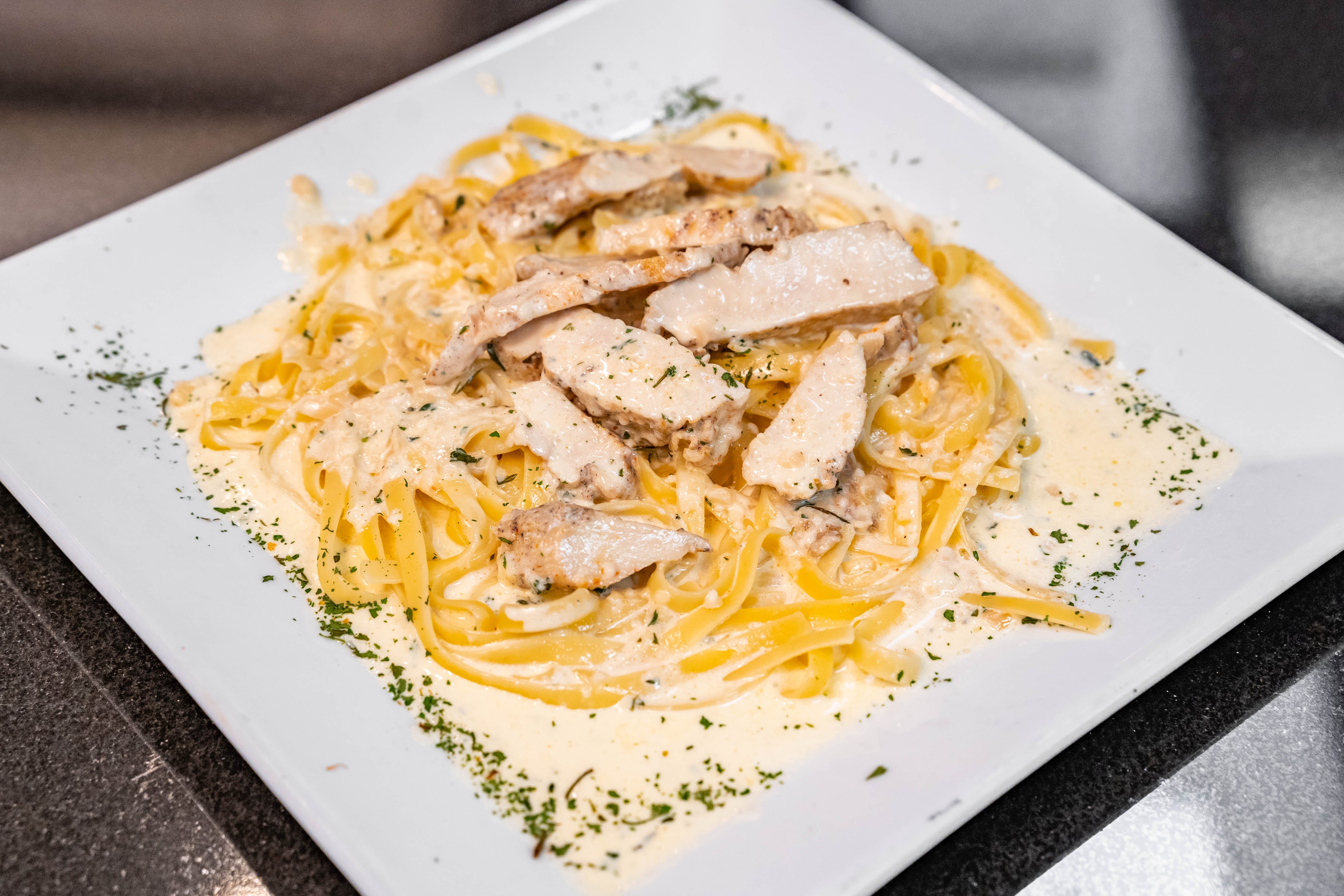 Order Fettucini Alfredo with Chicken - Entree food online from Father & Sons store, Woodbury on bringmethat.com