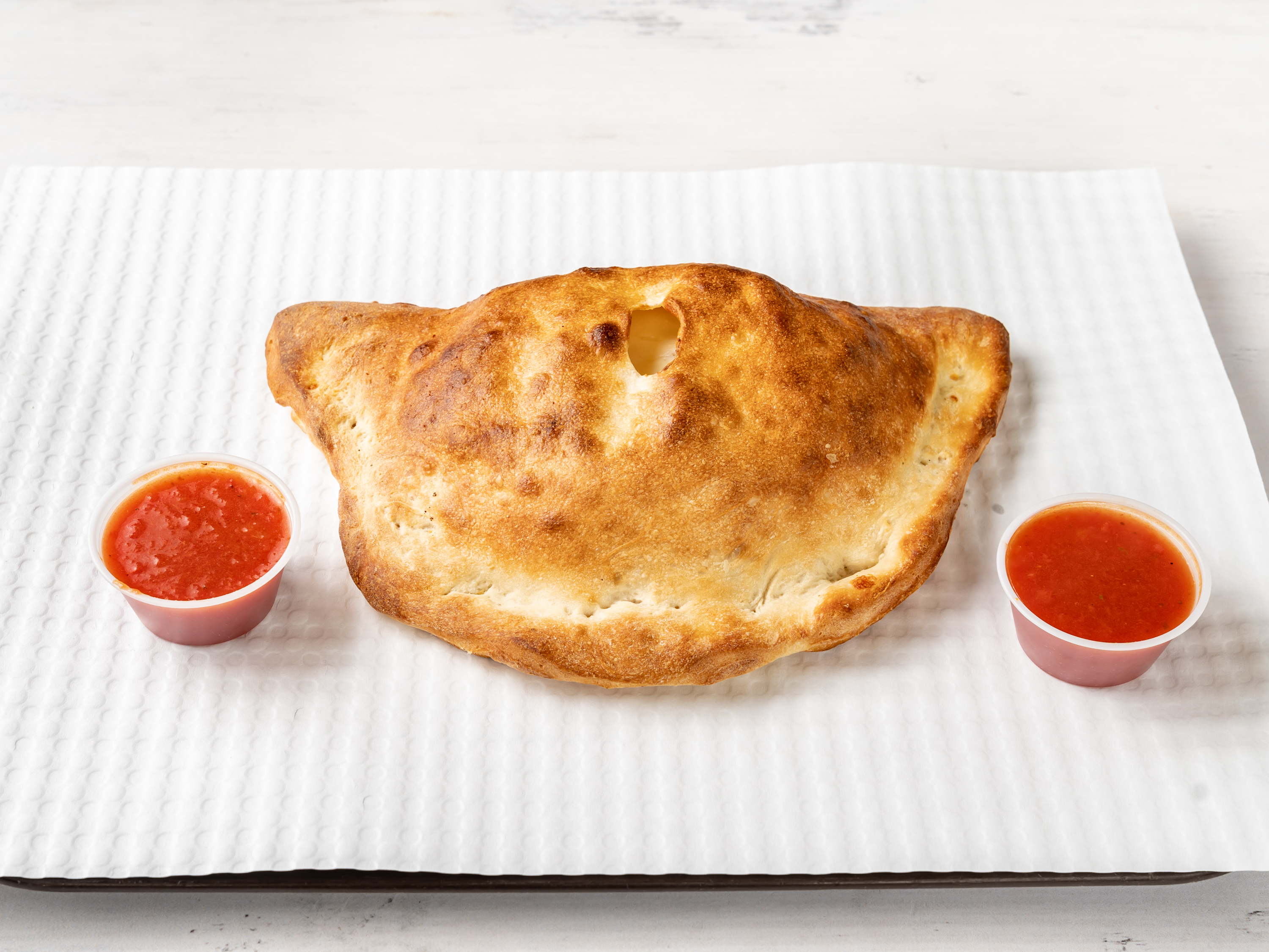 Order Cheesy Calzone  food online from East Village Pizza & Kebabs store, New York on bringmethat.com
