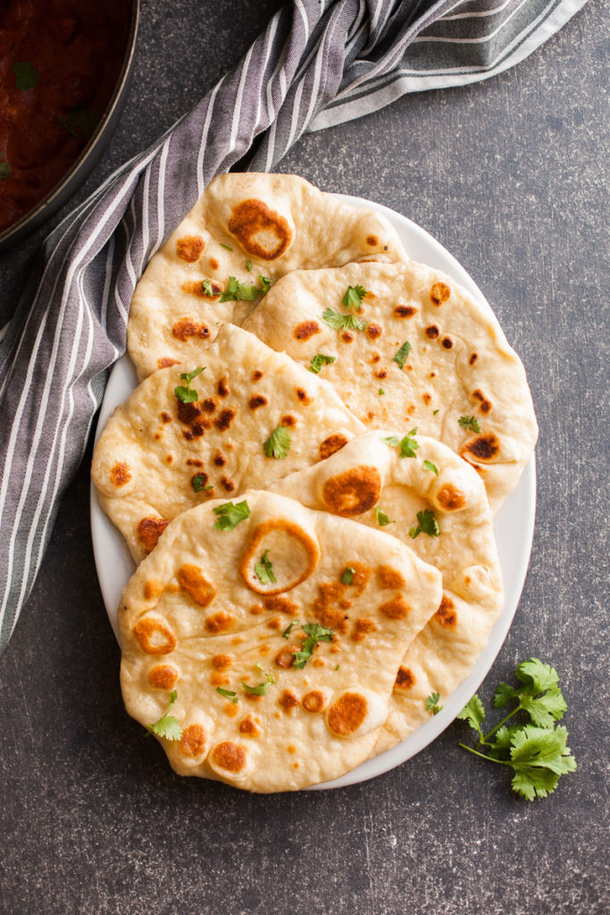 Order Garlic Naan food online from King of Tandoor Fine Indian Restaurant store, Philadelphia on bringmethat.com