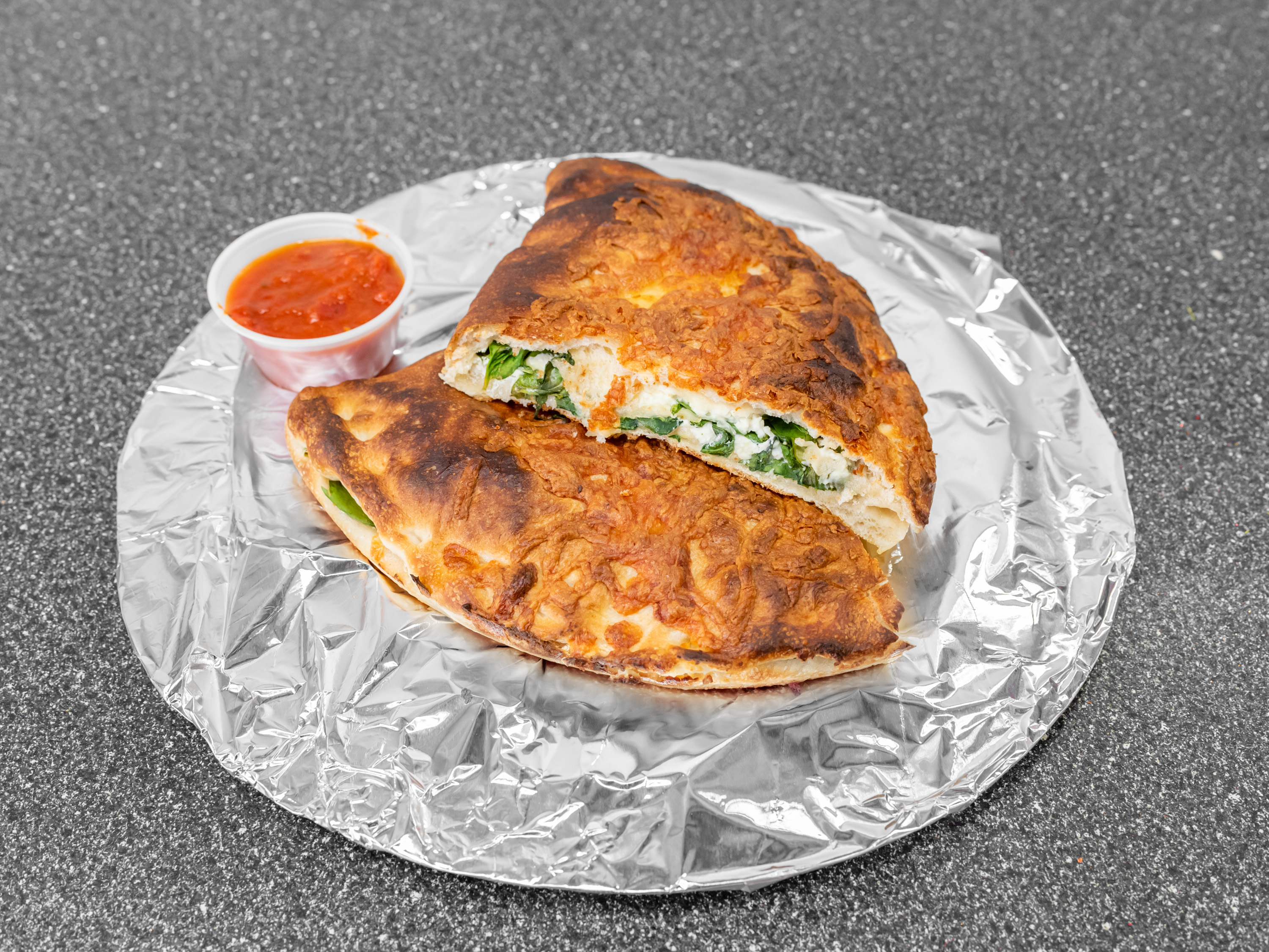 Order Spinach and Feta Calzone  food online from Bits & Bites Cafe store, Waltham on bringmethat.com