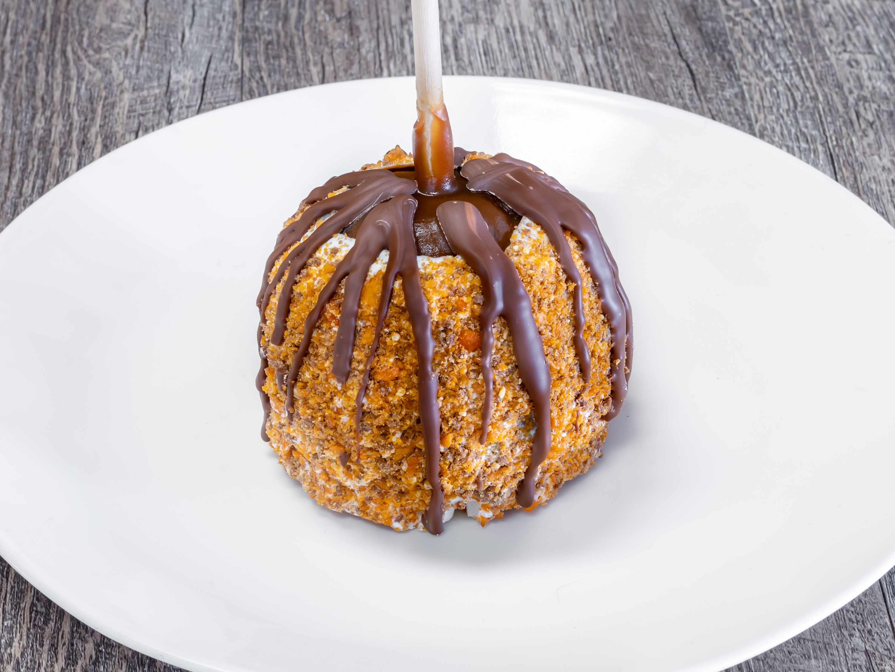 Order Butterfinger Apple food online from Rocky Mountain Chocolate Factory store, Houston on bringmethat.com
