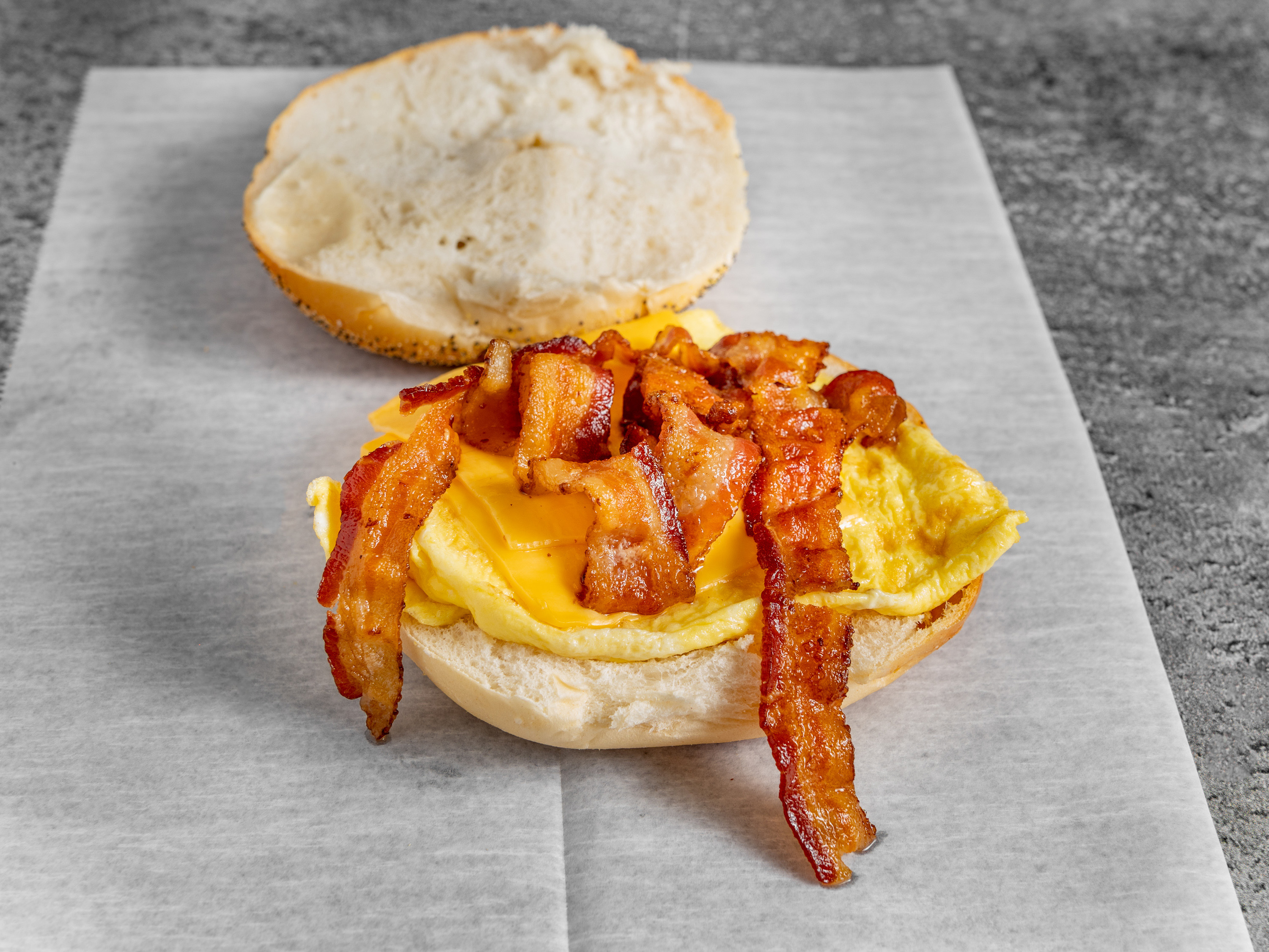 Order B2. Two Eggs on Roll With Bacon food online from Meadow Deli store, East Meadow on bringmethat.com
