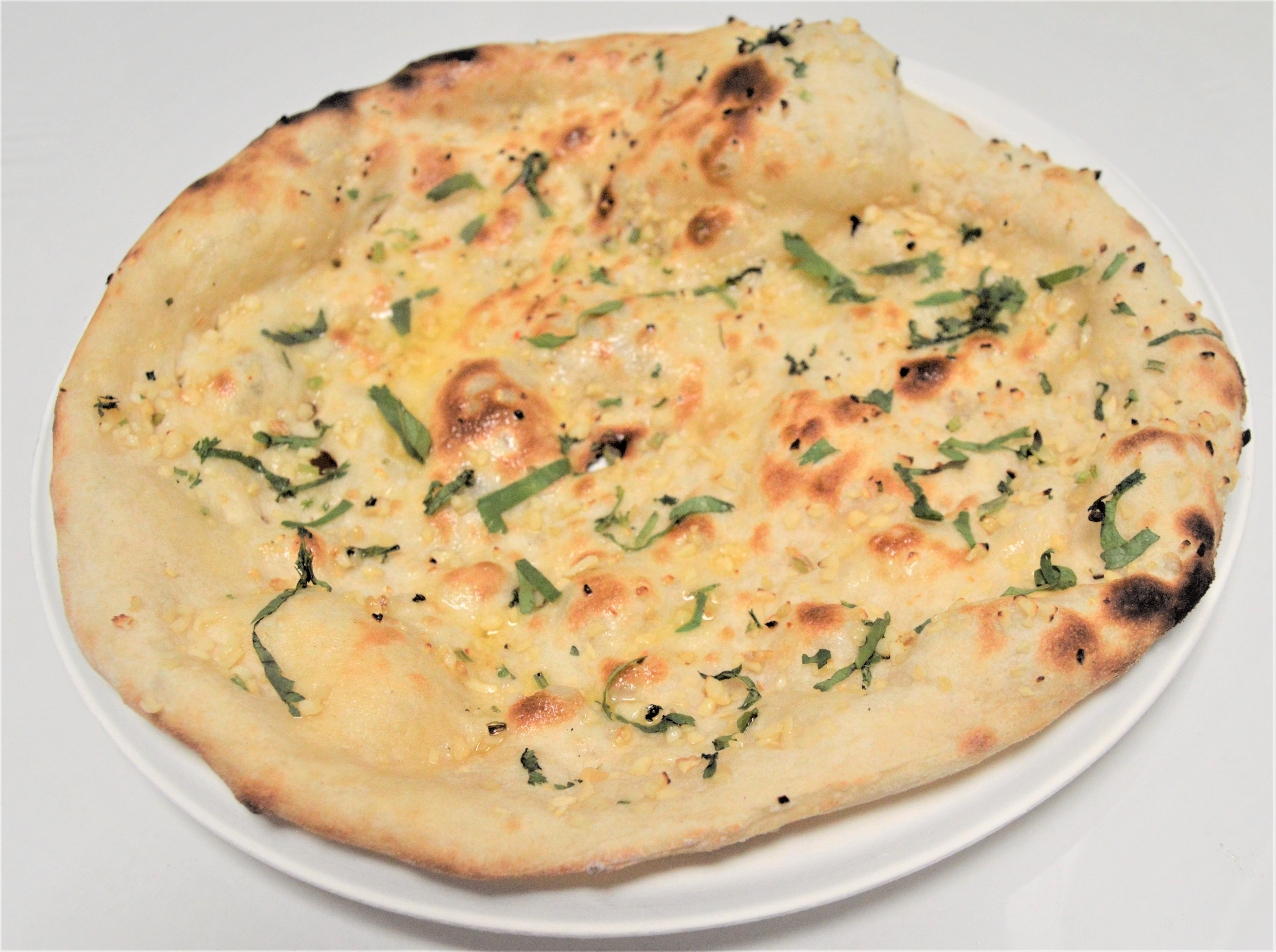 Order 17. Garlic Naan food online from Salt And Pepper Grill Iii store, Washington on bringmethat.com