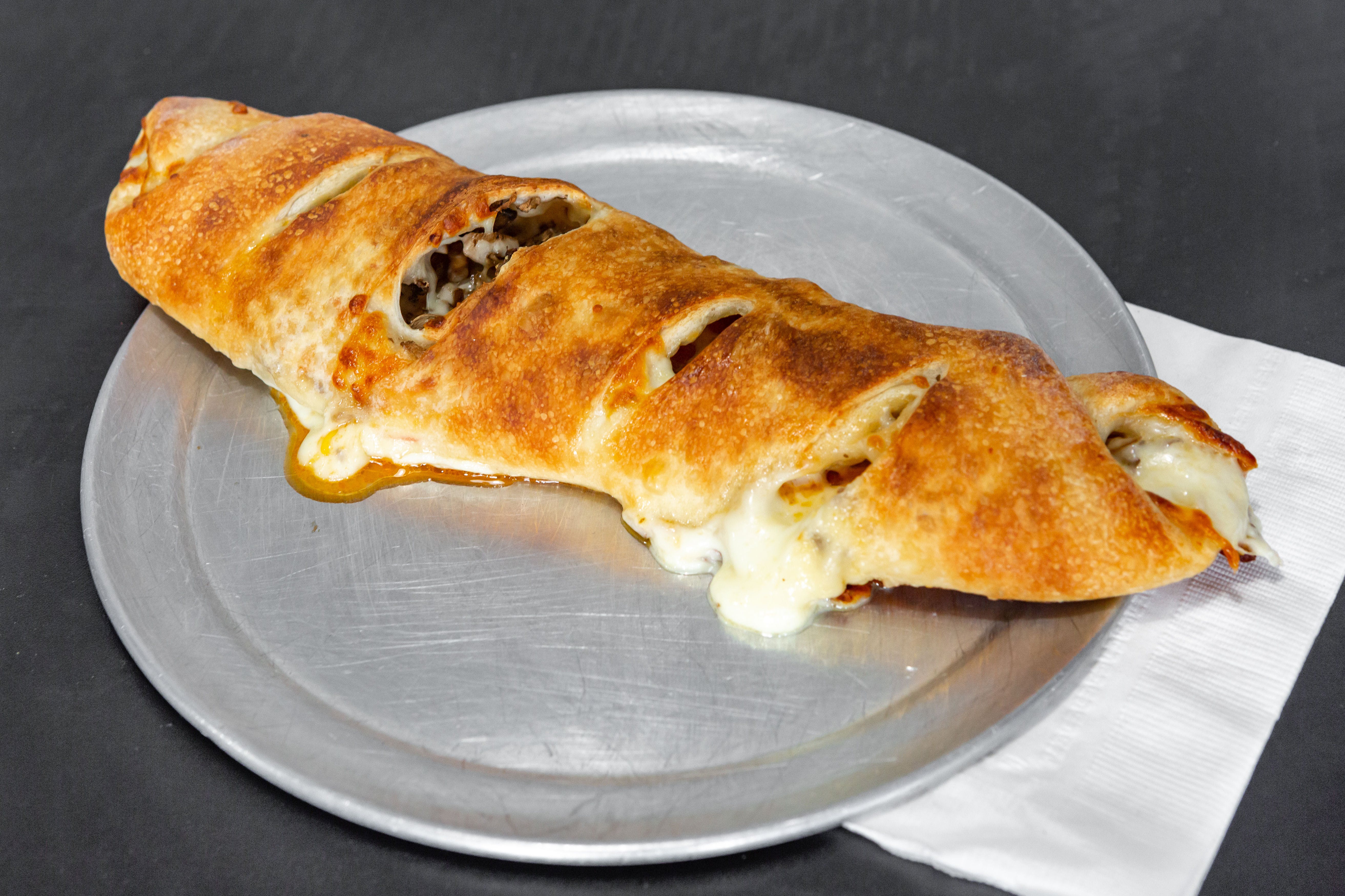 Order Stromboli - Calzone food online from Tangy Tomato store, Syracuse on bringmethat.com