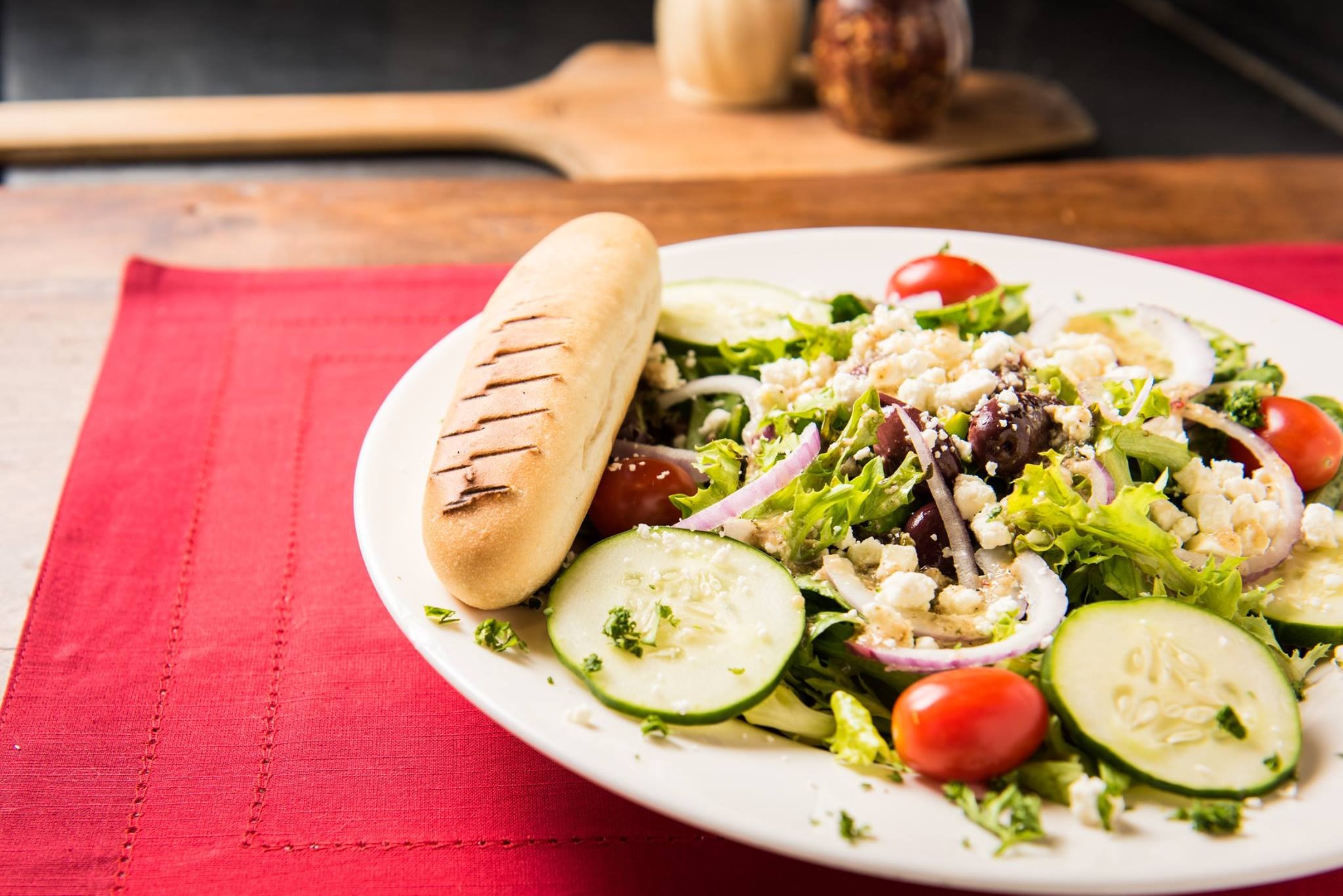 Order Greek Salad food online from Pagliais Pizza store, Johnston on bringmethat.com