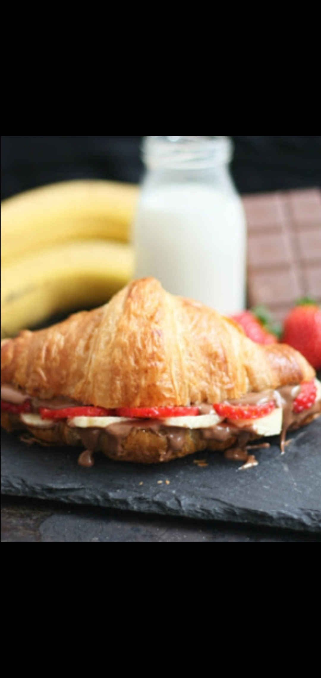 Order Croissant With Banana, Nutella & Strawberries  food online from American Gourmet Foods Deli store, New York on bringmethat.com