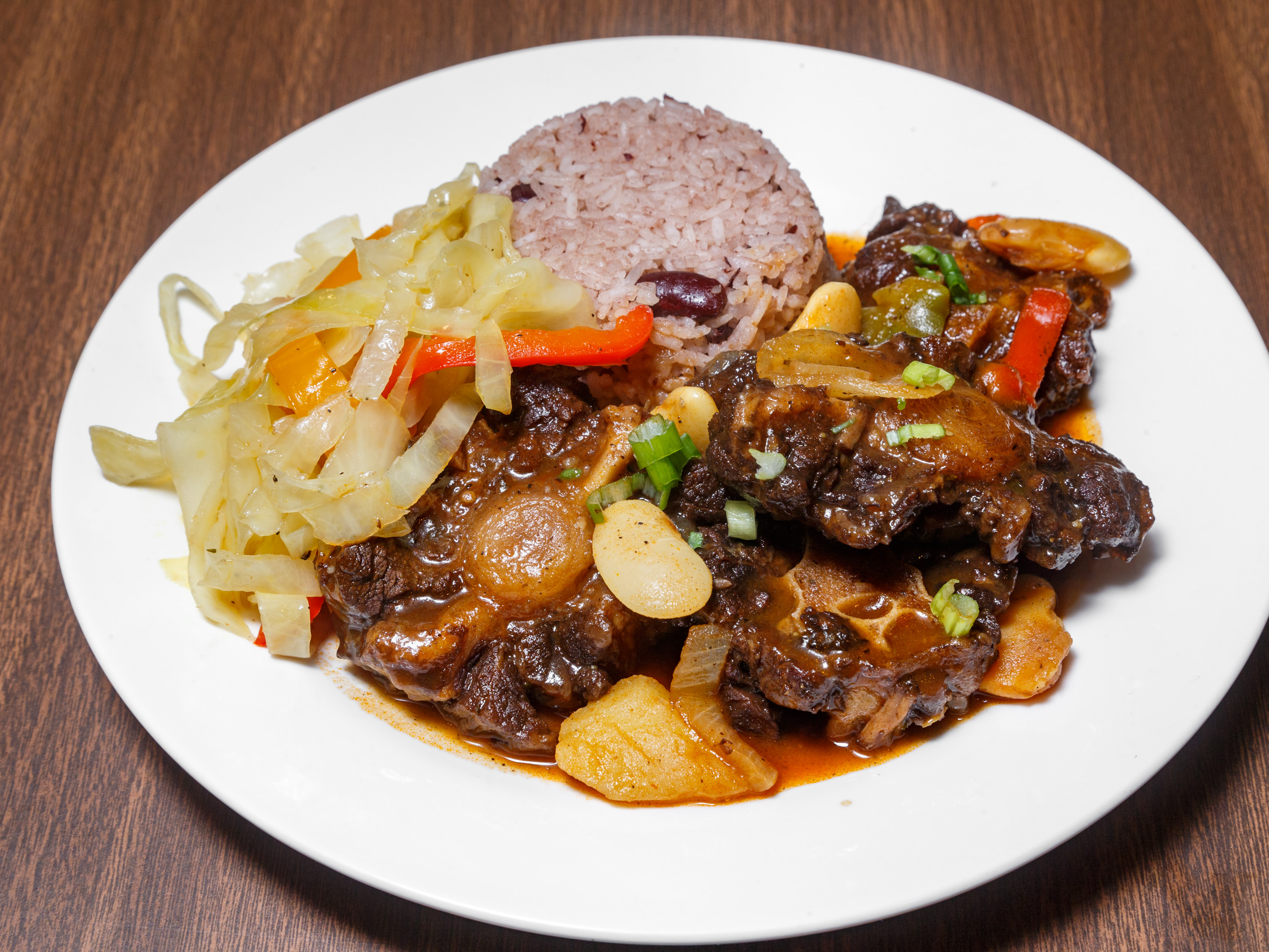 Order Oxtail food online from Doug Caribbean Kitchen store, Pittsburgh on bringmethat.com