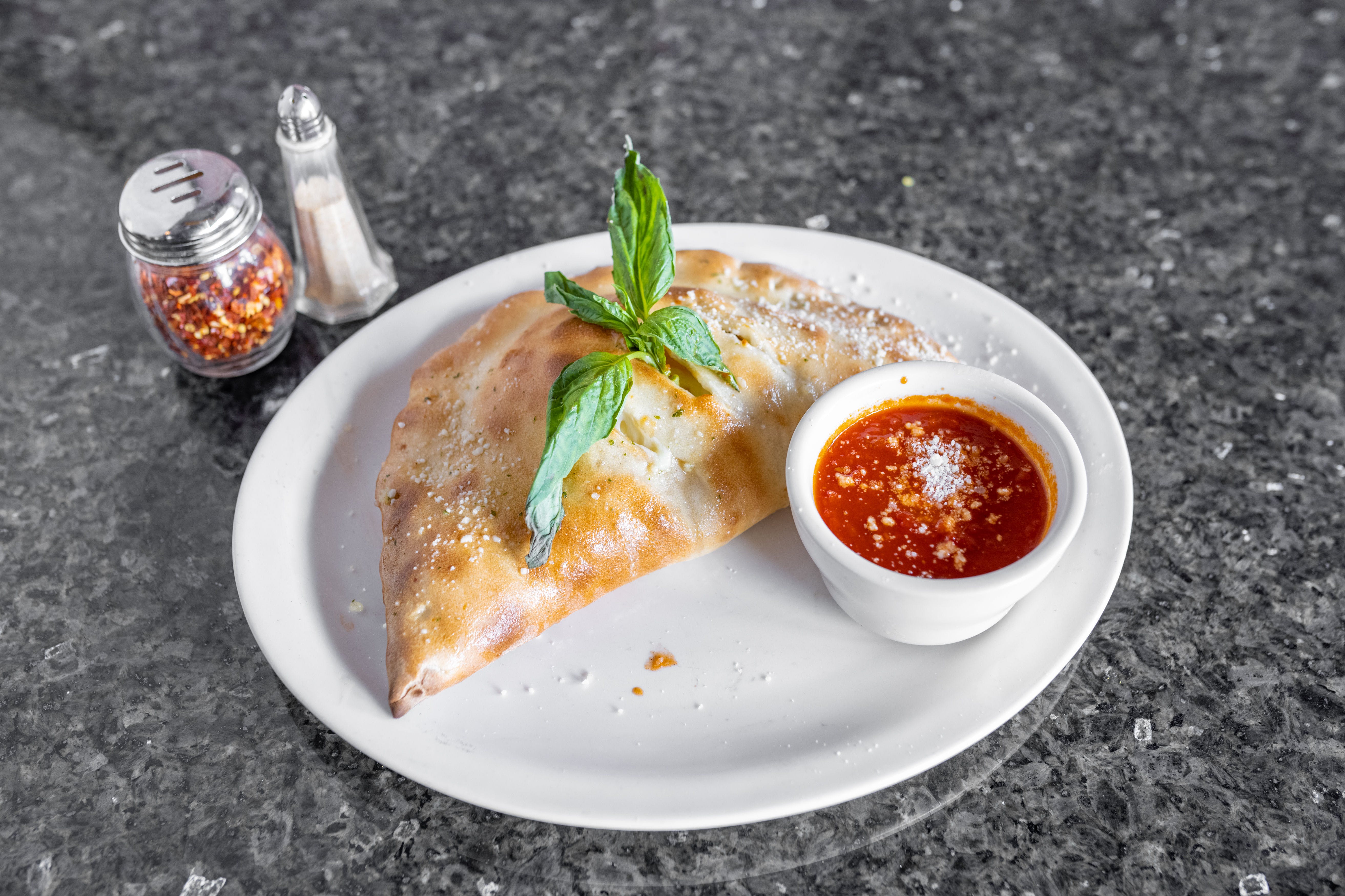 Order Ham Calzone - Individual food online from John's Of Arthur Ave Restaurant store, Middletown on bringmethat.com