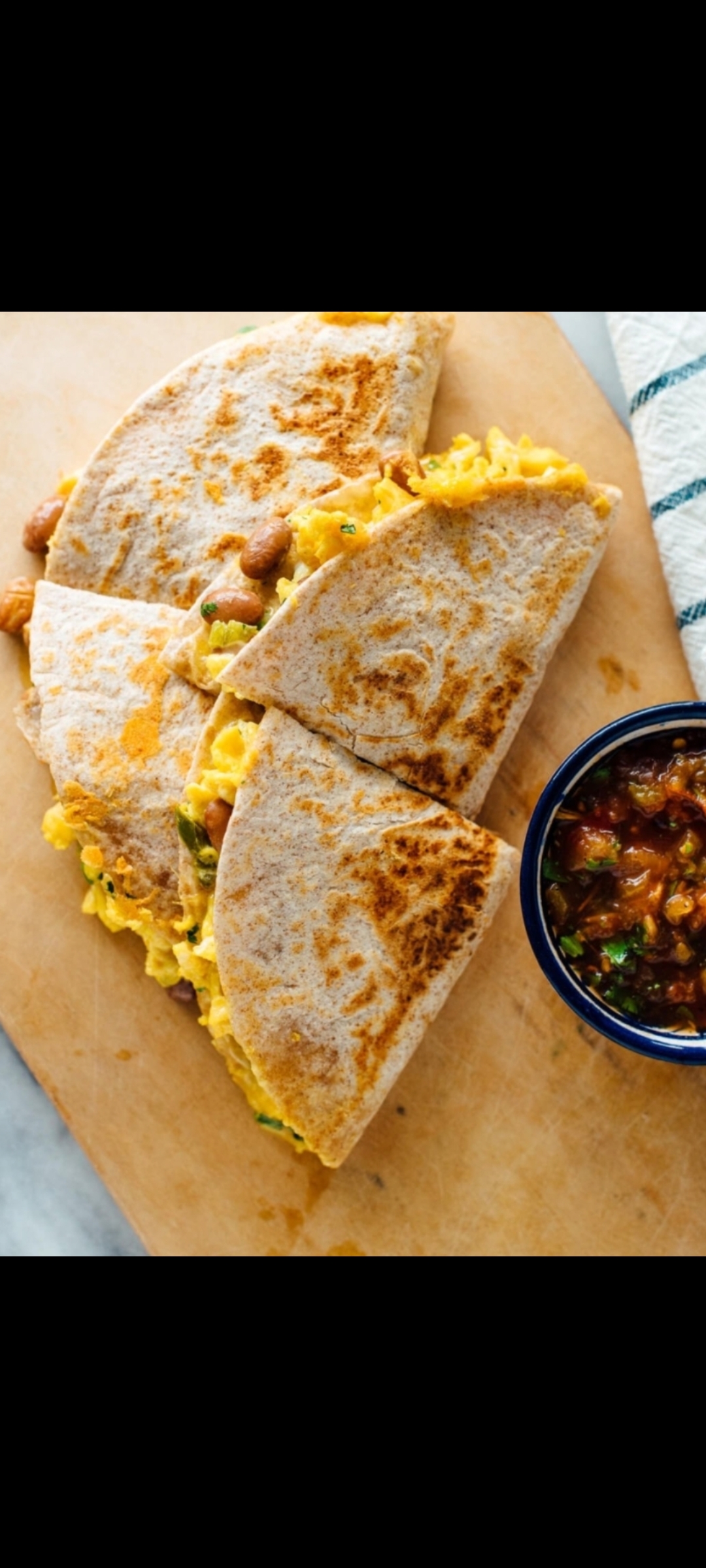 Order Traditional Quesadilla (eggs,black beans, cholula hot sauce green onions, chopped pickled jalapeños, cilantro, cheddar cheese & side salsa verde) food online from American Gourmet Foods Deli store, New York on bringmethat.com