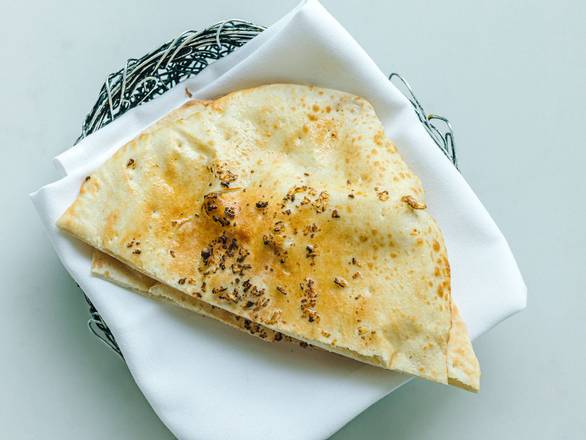 Order Garlic Naan by All Day food online from Uncooked store, Chicago on bringmethat.com