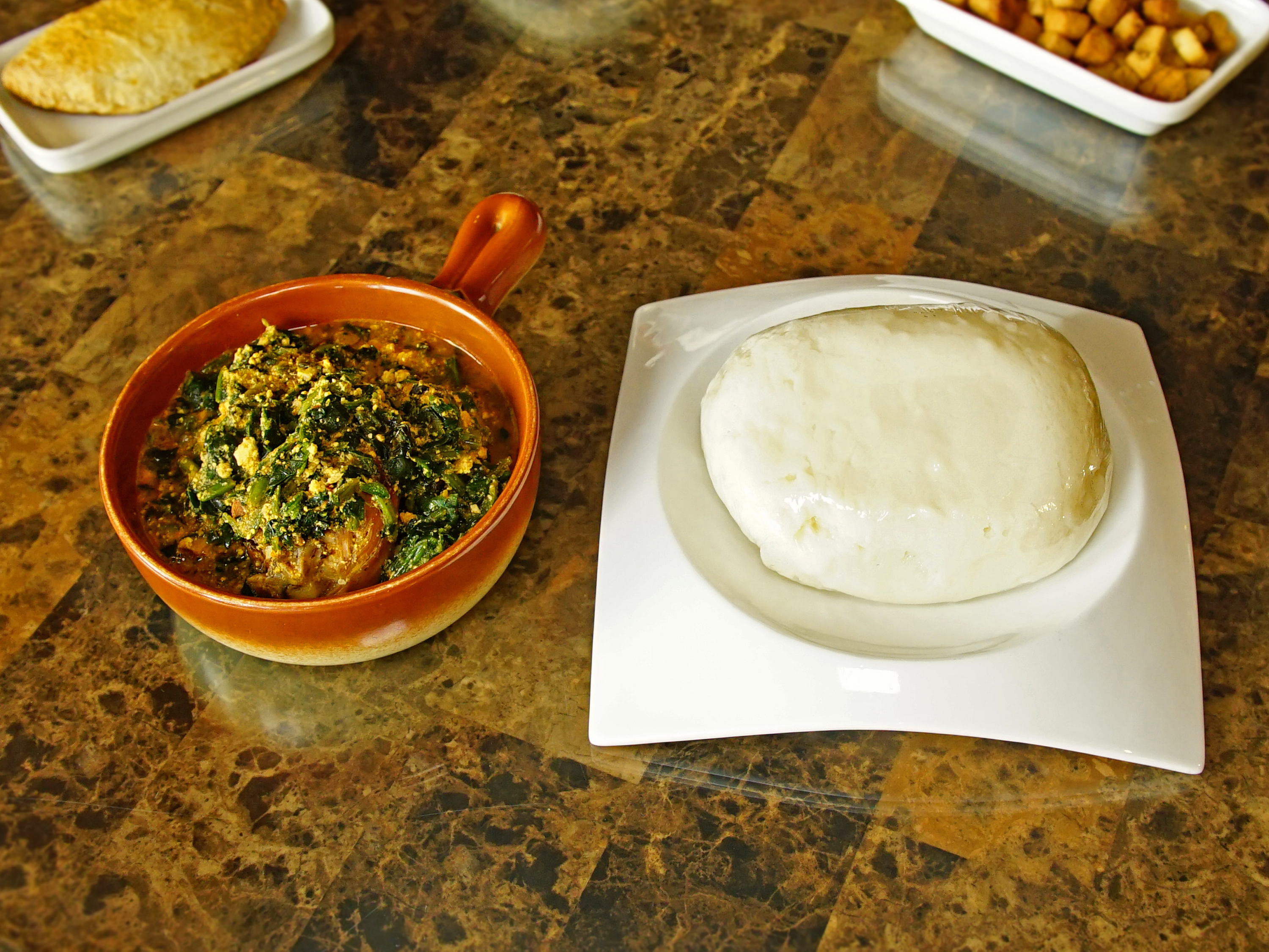 Order Egusi Soup food online from Totos’ African Cuisine store, Van Nuys on bringmethat.com