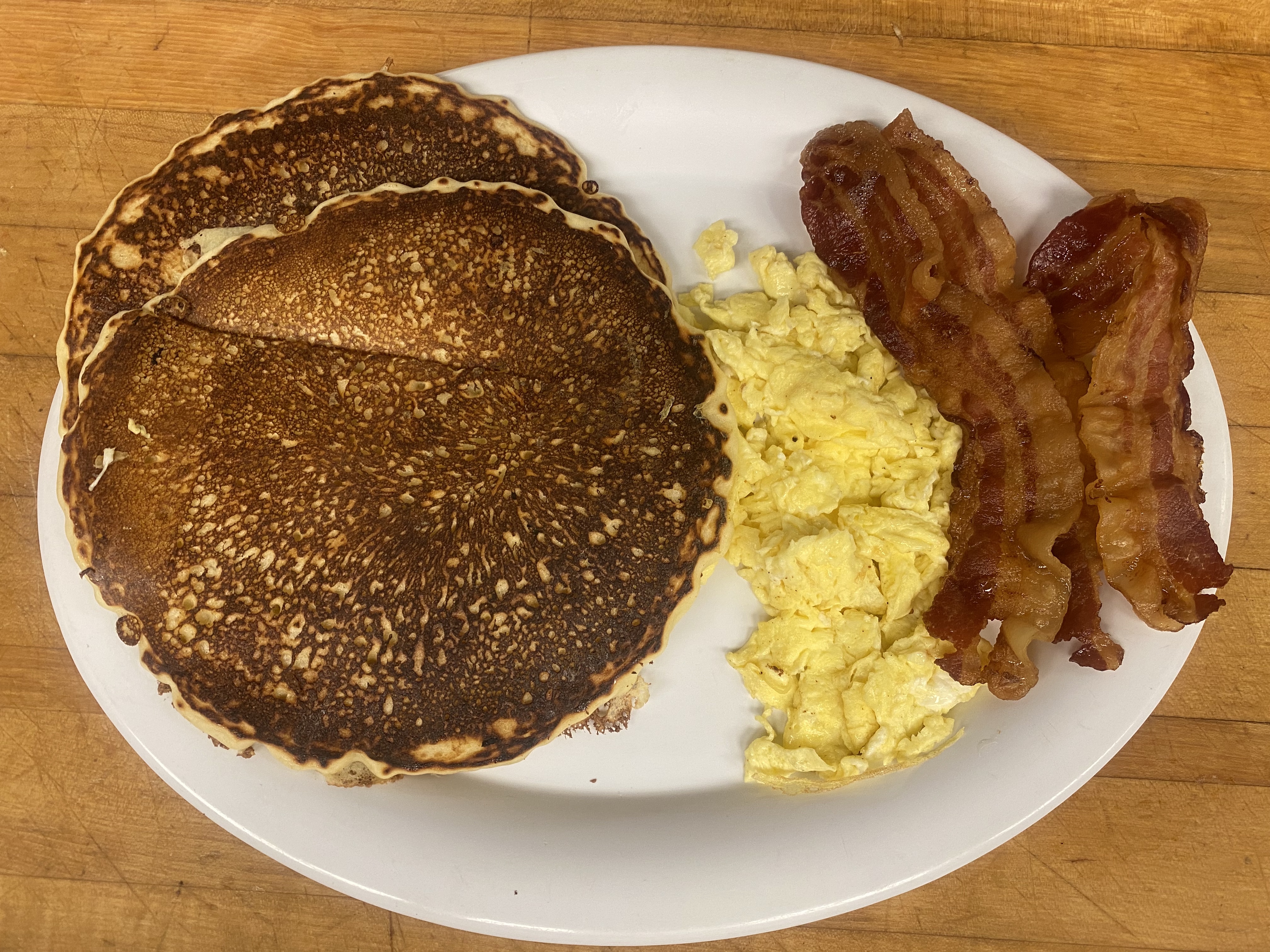 Order 2 Pancakes, 2 Eggs with Choice of Meat Breakfast food online from Papermill Place Restaurant store, Winchester on bringmethat.com