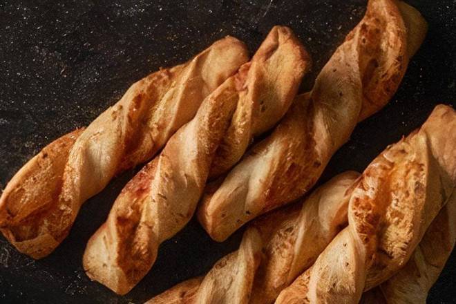 Order Garlic Parmesan Twists food online from Round Table Pizza store, Citrus Heights on bringmethat.com