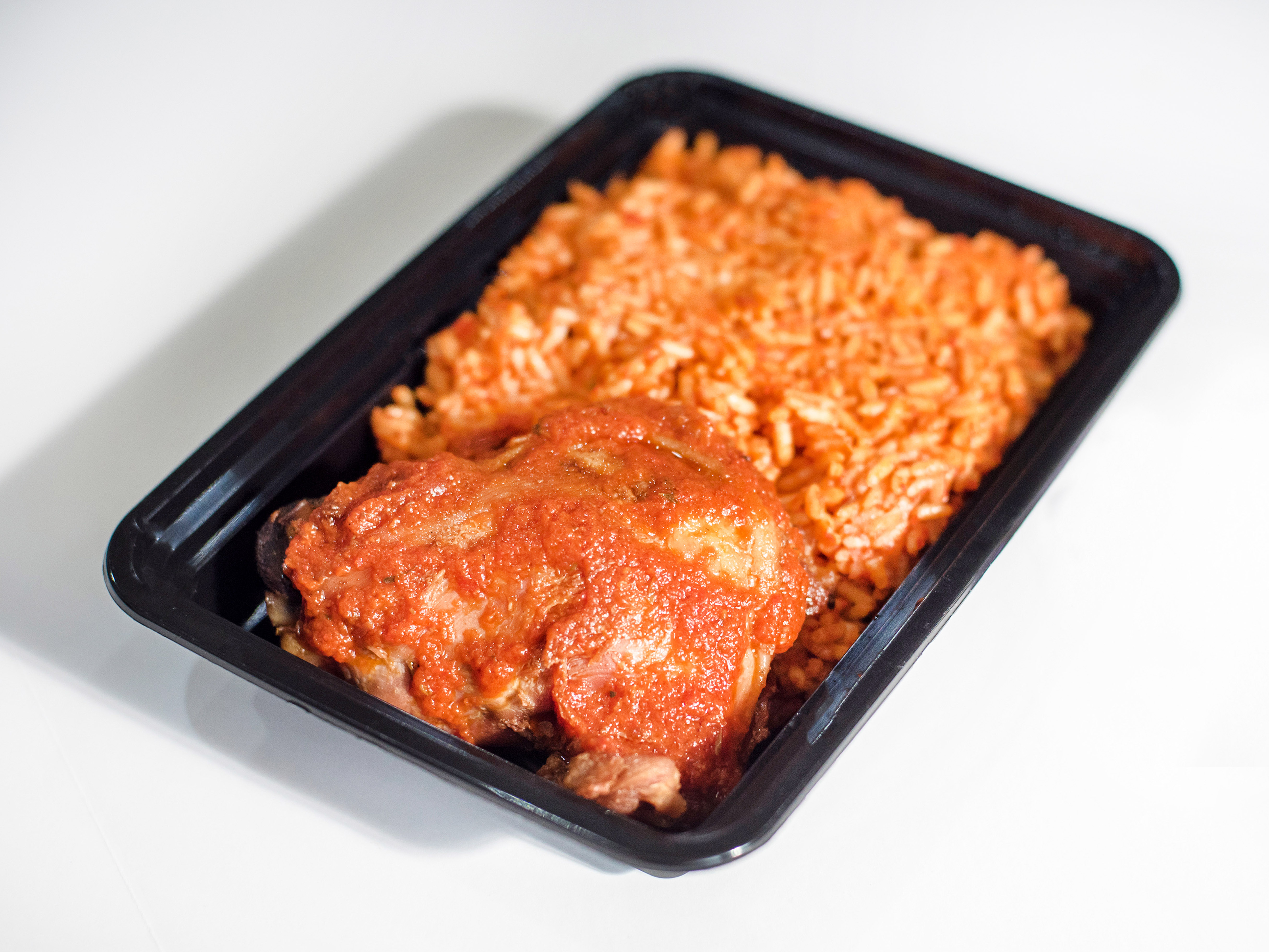 Order Chicken and Jollof Rice food online from African Caribbean Food Market store, Oakland on bringmethat.com