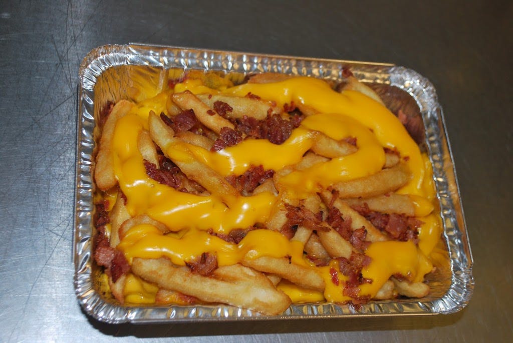 Order French Fries with Cheese Sauce & Bacon - Appetizer food online from Peppercini Italian Restaurant & Lounge store, Mc Kees Rocks on bringmethat.com