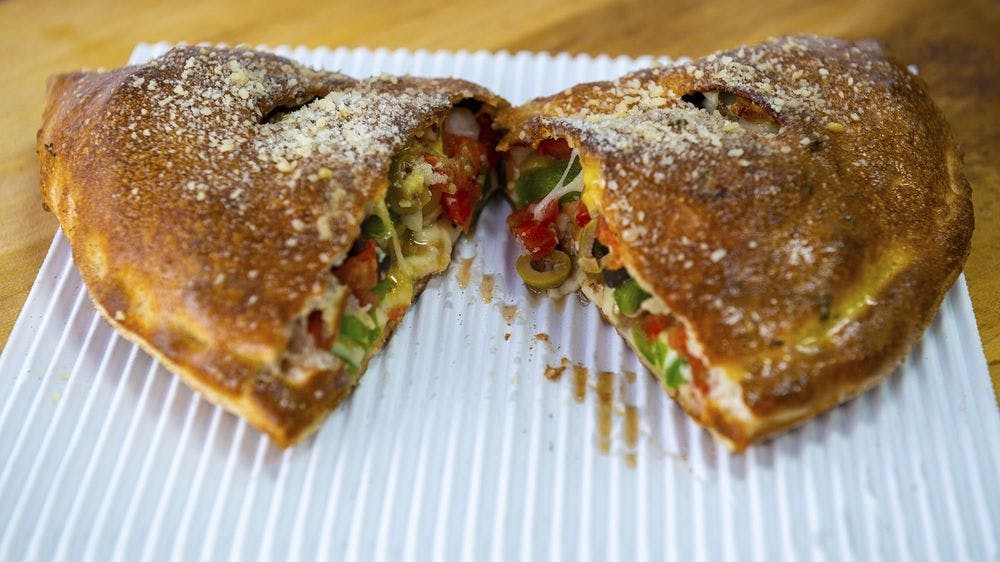 Order Veggie Calzone - Large food online from Benito's Pizza - South Lyon store, South Lyon on bringmethat.com