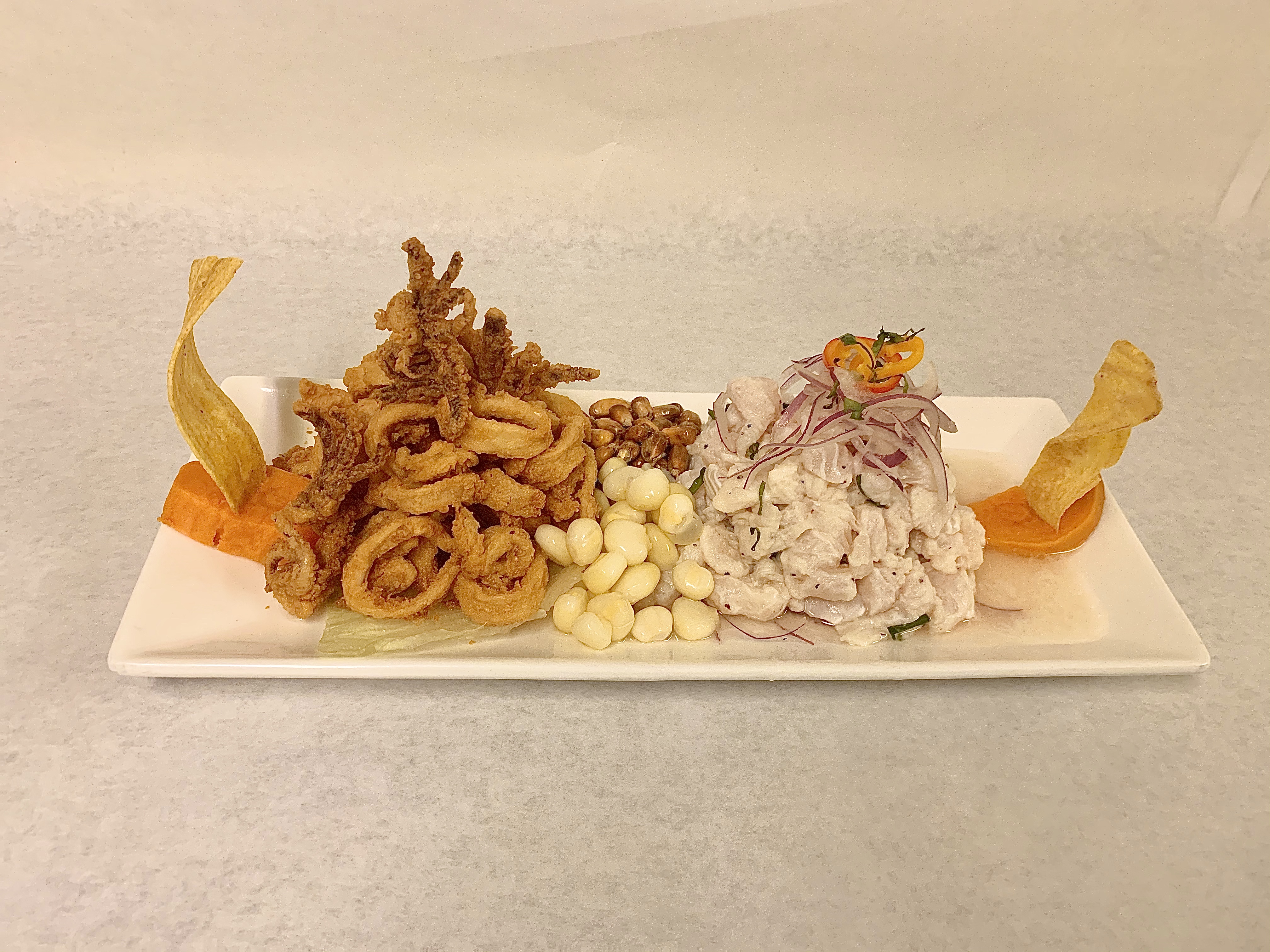Order Ceviche 2 en 1 ( fish ceviche with fried calamari) food online from Mancora Resturant store, Sleepy Hollow on bringmethat.com
