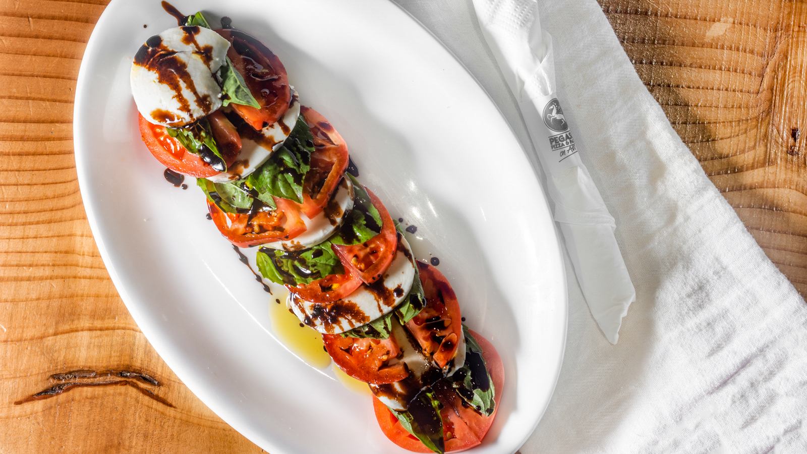 Order Caprese Salad food online from Pegasus Pizza and Pasta store, Seattle on bringmethat.com