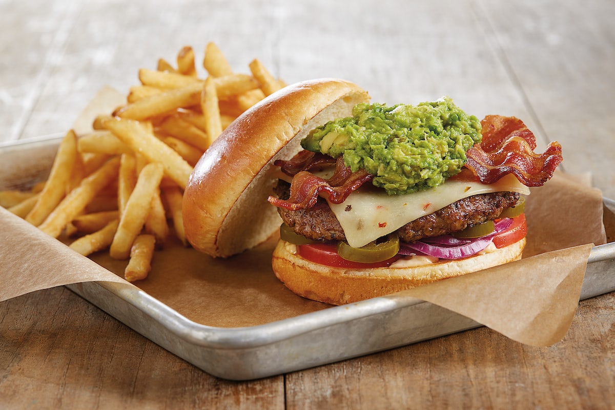 Order Bacon-Guacamole Deluxe Burger* food online from Bj Restaurant & Brewhouse store, Livonia on bringmethat.com