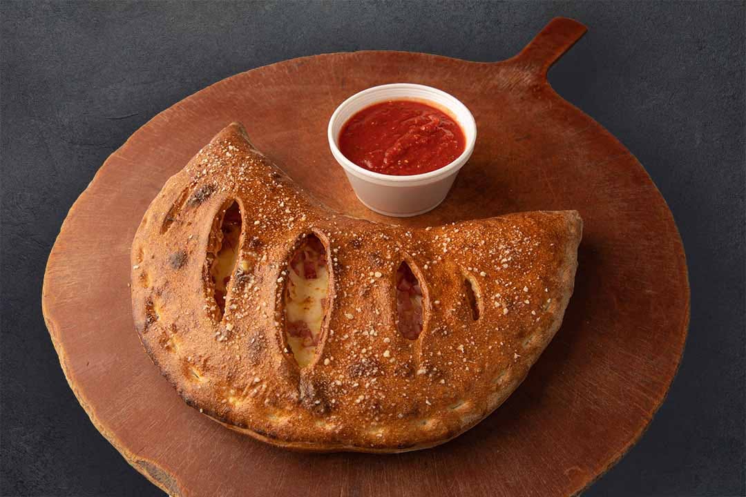 Order Meateaters Calzone - Half food online from Westshore Pizza store, Tampa on bringmethat.com