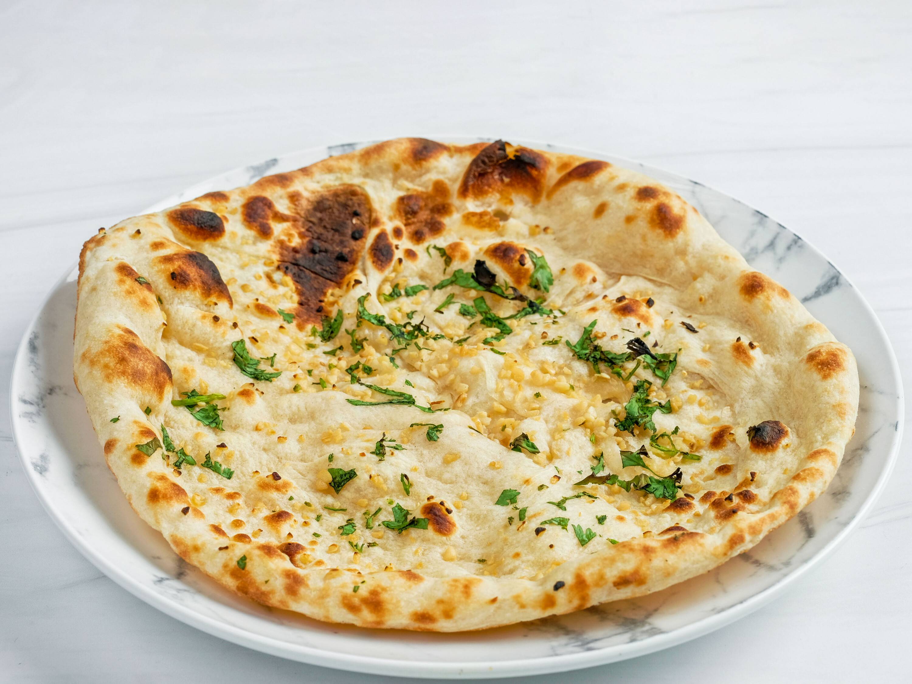Order Garlic Naan food online from Kwality Kabab & Grill store, Carrollton on bringmethat.com