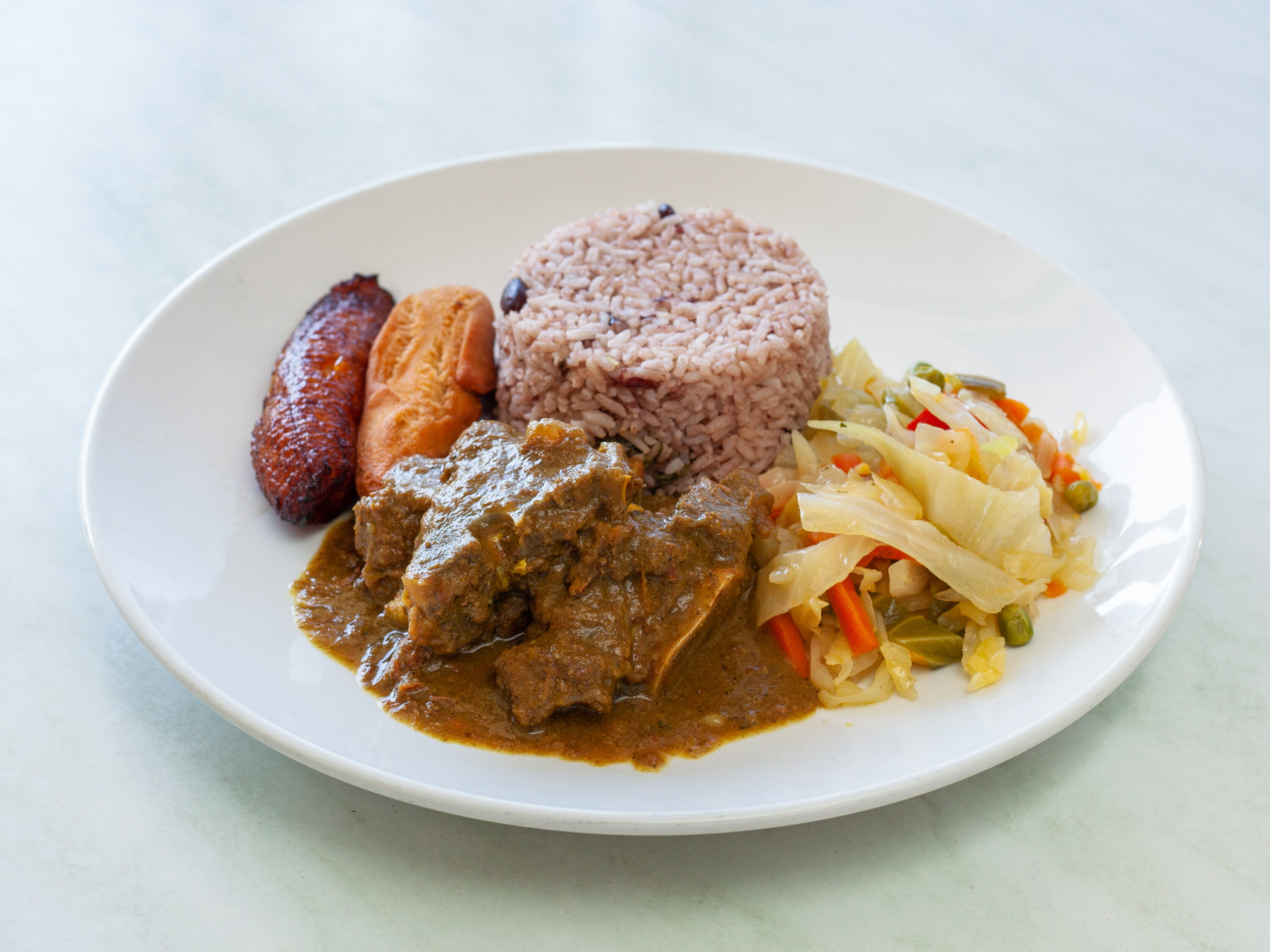 Order Curry Goat food online from One876 Caribbean Restaurant store, Chatsworth on bringmethat.com