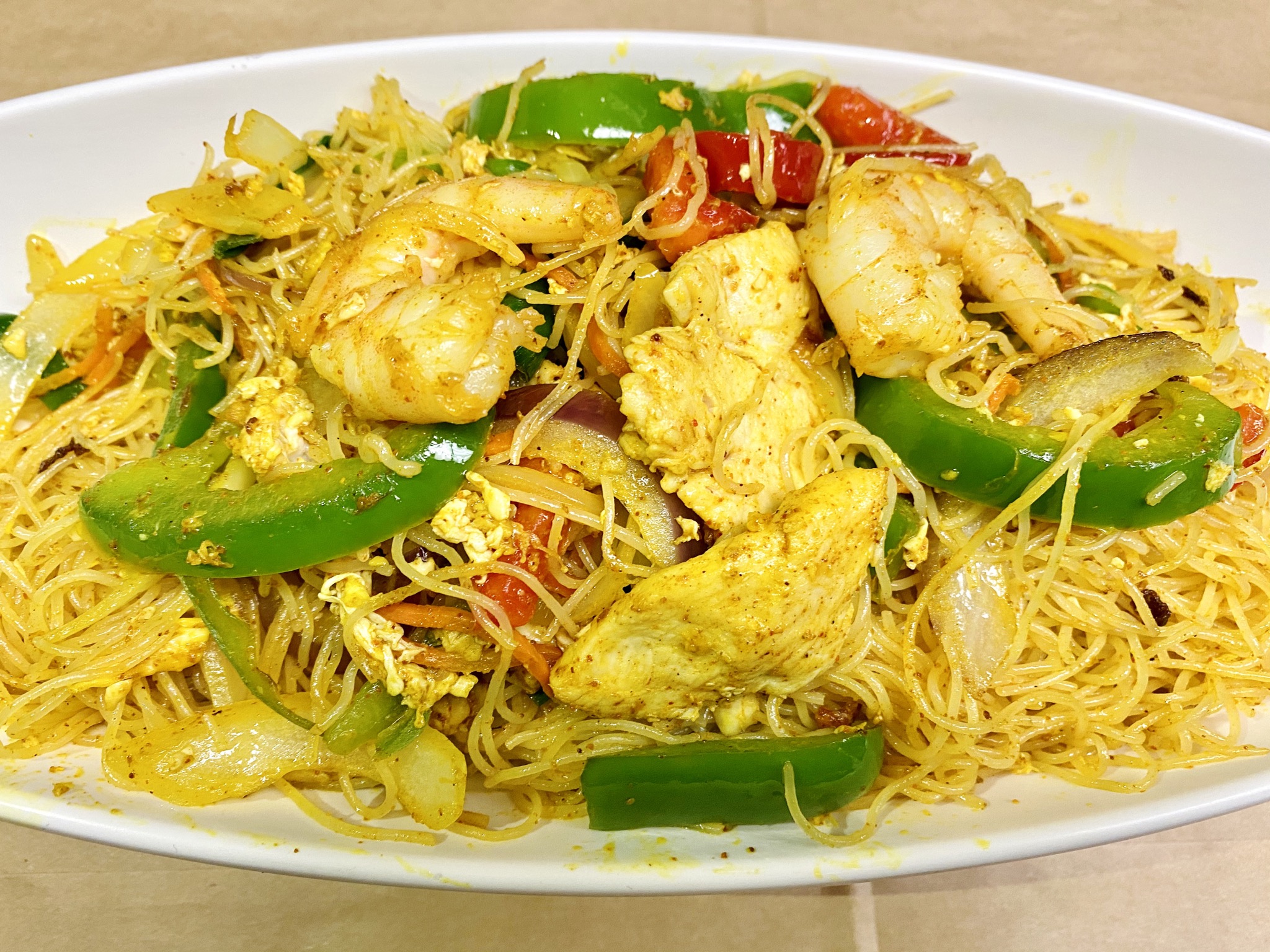 Order  Singapore Rice Noodle food online from Min Min Asian Cafe store, Chicago on bringmethat.com