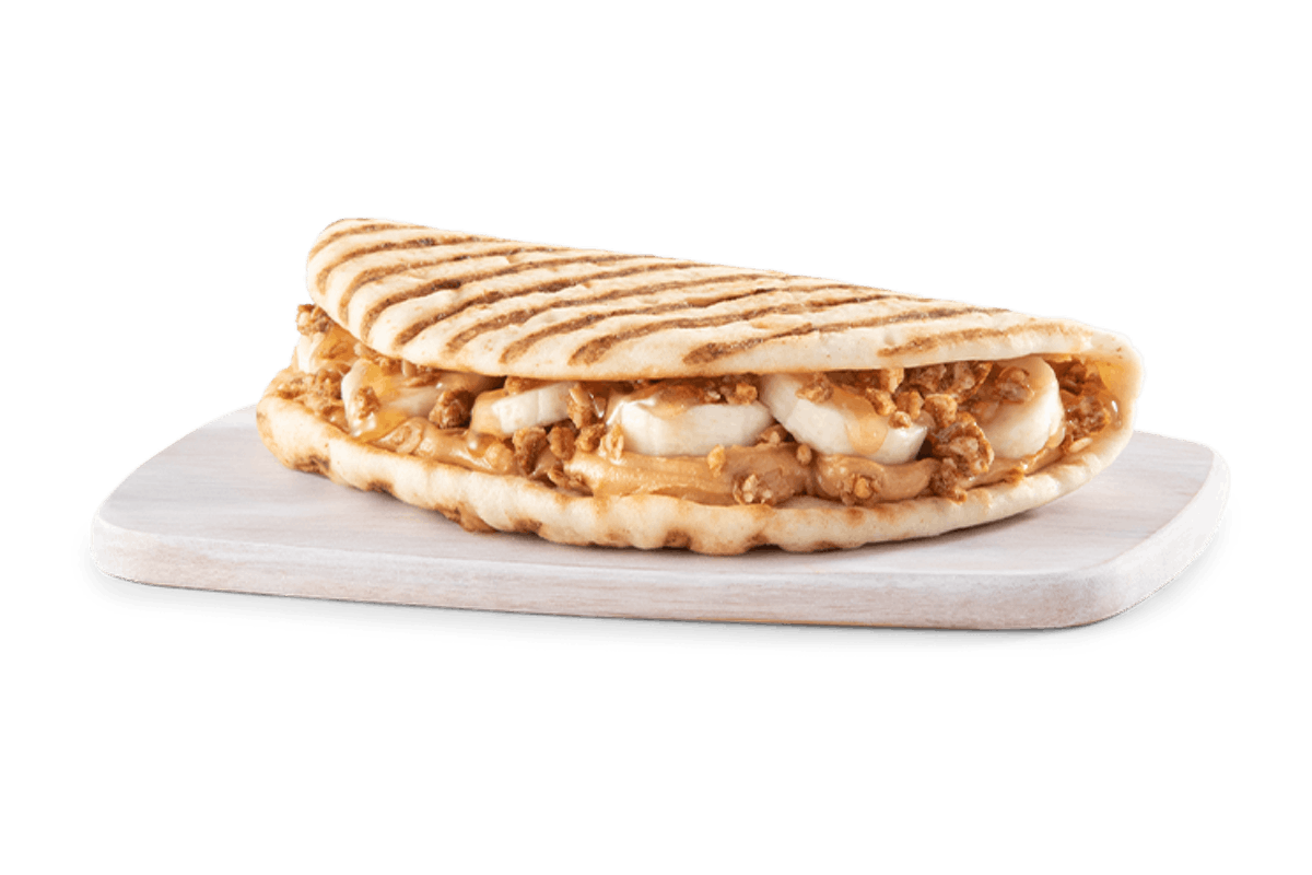 Order PEANUT BUTTER BANANA CRUNCH FLATBREAD food online from Tropical Smoothie Cafe - N. Mall Dr. store, Virginia Beach on bringmethat.com