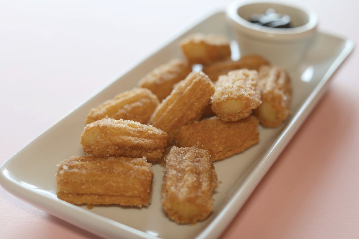 Order Dozen Churro Bites with Chocolate Sauce food online from Savage Burrito store, Gainesville on bringmethat.com