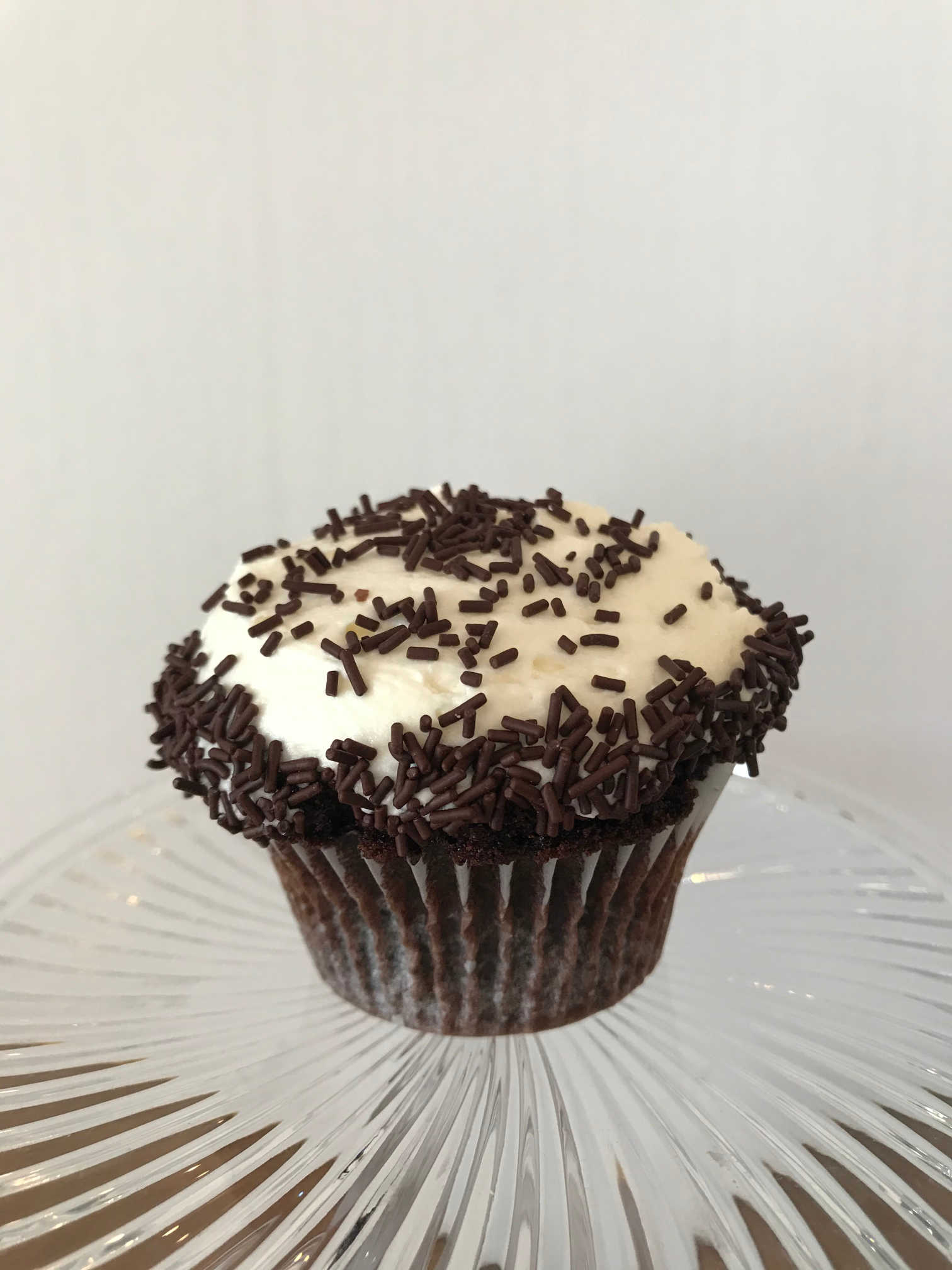Order Vanilla on Chocolate Cupcake food online from Sugar Blossom Bake Shop store, San Clemente on bringmethat.com