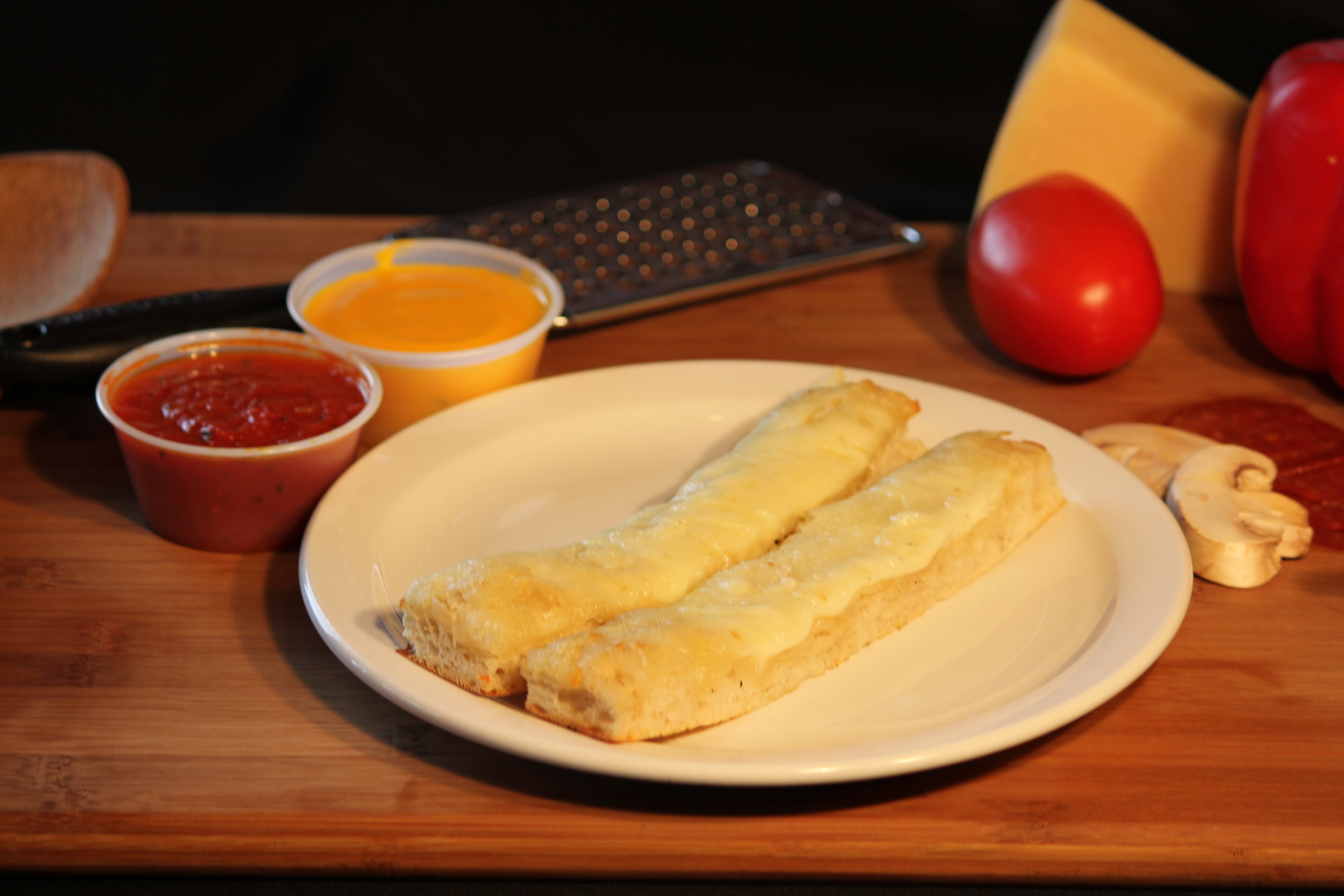 Order Mozzarella Topped Breadsticks - 1 Piece food online from Luca Pizza Di Roma store, Findlay on bringmethat.com