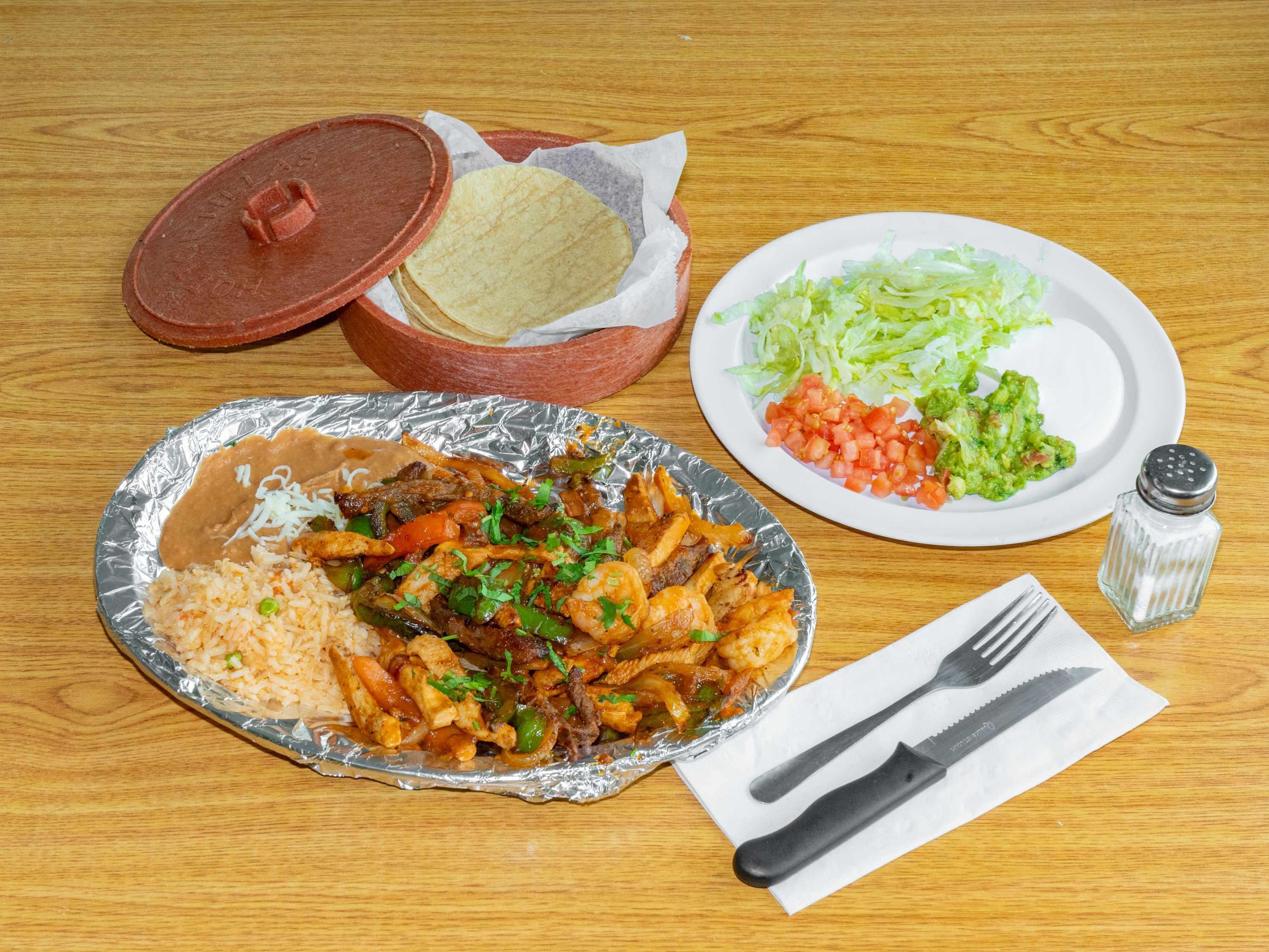 Order Steak, Chicken and Shrimp Fajitas food online from Whata Taco Authentic Mexican Food store, Country Club Hills on bringmethat.com