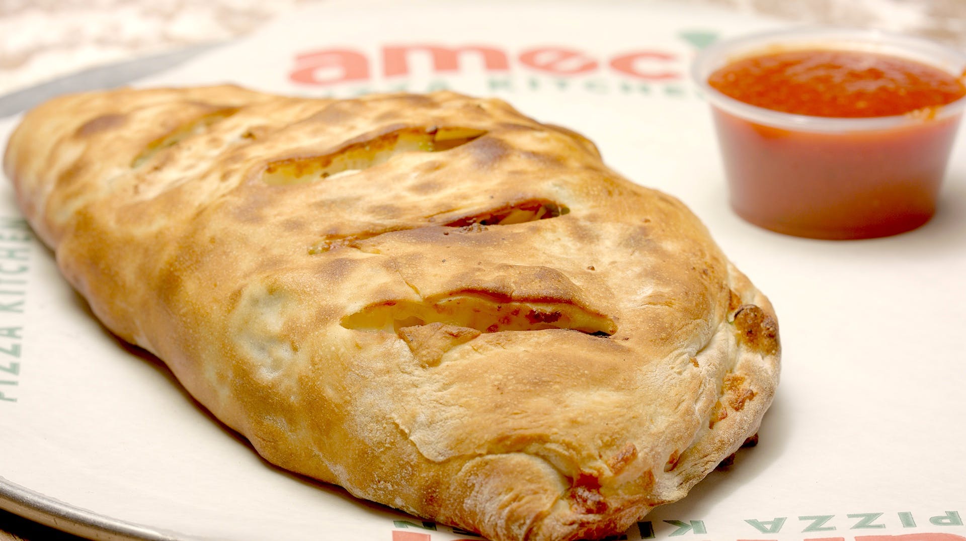 Order Meatlovers Calzone - Calzone food online from Ameci Pizza & Pasta store, Canyon Country on bringmethat.com
